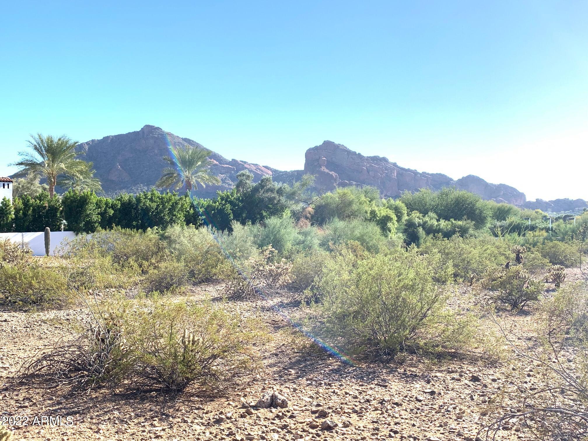 THE BEST Paradise Valley lot with unobstructed panoramic views of Camelback Mountain, Mummy Mountain, Arizona sunsets and sparkling city lights. It's the only true south facing backyard in Paradise Valley Estates neighborhood, non front loaded, and also does not fall under hillside zoning. The oversized lot is an entertainer's dream with ample space for an amazing custom home featuring a resort style backyard, tennis court and anything you can dream up. Ideally located just minutes to the Paradise Valley Country Club, JW Camelback Inn Resort & Spa, Scottsdale Fashion Square, many popular restaurants, world renowned golf courses, hiking, cycling and walking trails.