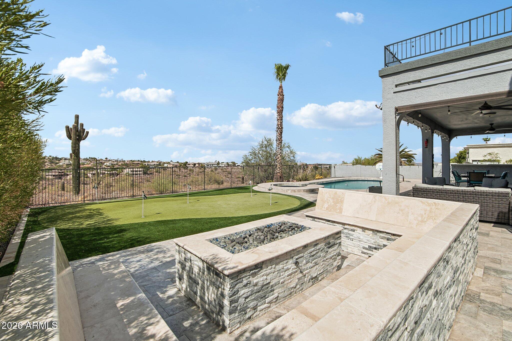 Million-dollar views of Four Peaks, the Mazatzal Mountains, and the iconic Fountain Hills fountain set this extraordinary home apart. Perfectly positioned on a premium open-space lot, this beautifully remodeled residence offers some of the most breathtaking panoramic views in Fountain Hills, creating a spectacular backdrop from sunrise to sunset. Designed to maximize Arizona's indoor-outdoor lifestyle, the resort-style backyard has been completely transformed with over $300,000 in upgrades. Relax in the heated pool and spa, entertain around the built-in outdoor kitchen and fire pit, practice your putting on the private putting green, and enjoy the elegance of leathered marble throughout the outdoor living spaces--all while taking in the stunning mountain and fountain views. Inside, the home has been completely remodeled with a spacious open floor plan, a Great Room with a fireplace, and a large bonus room with soaring vaulted ceilings and oversized picture windows that showcase the stunning landscape. The designer kitchen features quartz countertops, double ovens, and custom finishes, while the remodeled bathrooms, luxury vinyl plank flooring, brand-new windows, and gorgeous custom front door complete this exceptional home. The home has also been freshly painted throughout, including a premium Rhino Shield exterior coating designed for long-lasting beauty, durability, and low maintenance.
A rare opportunity to own one of Fountain Hills' premier view properties.