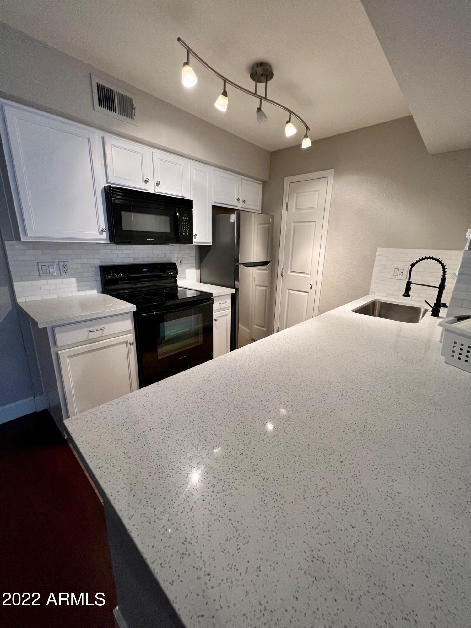 Updated first floor unit features wood laminate & tile flooring (no carpet) and Quartz countertops throughout. Kitchen has walk in pantry and Bedroom has walk in closet for extra storage. Unit includes indoor laundry (stacked washer/dryer) and oversized private patio with storage closet. Gated Community in the Biltmore/Arcadia area just minutes from the 51. Community also features pool/spa and assigned covered parking. Owner Agent.