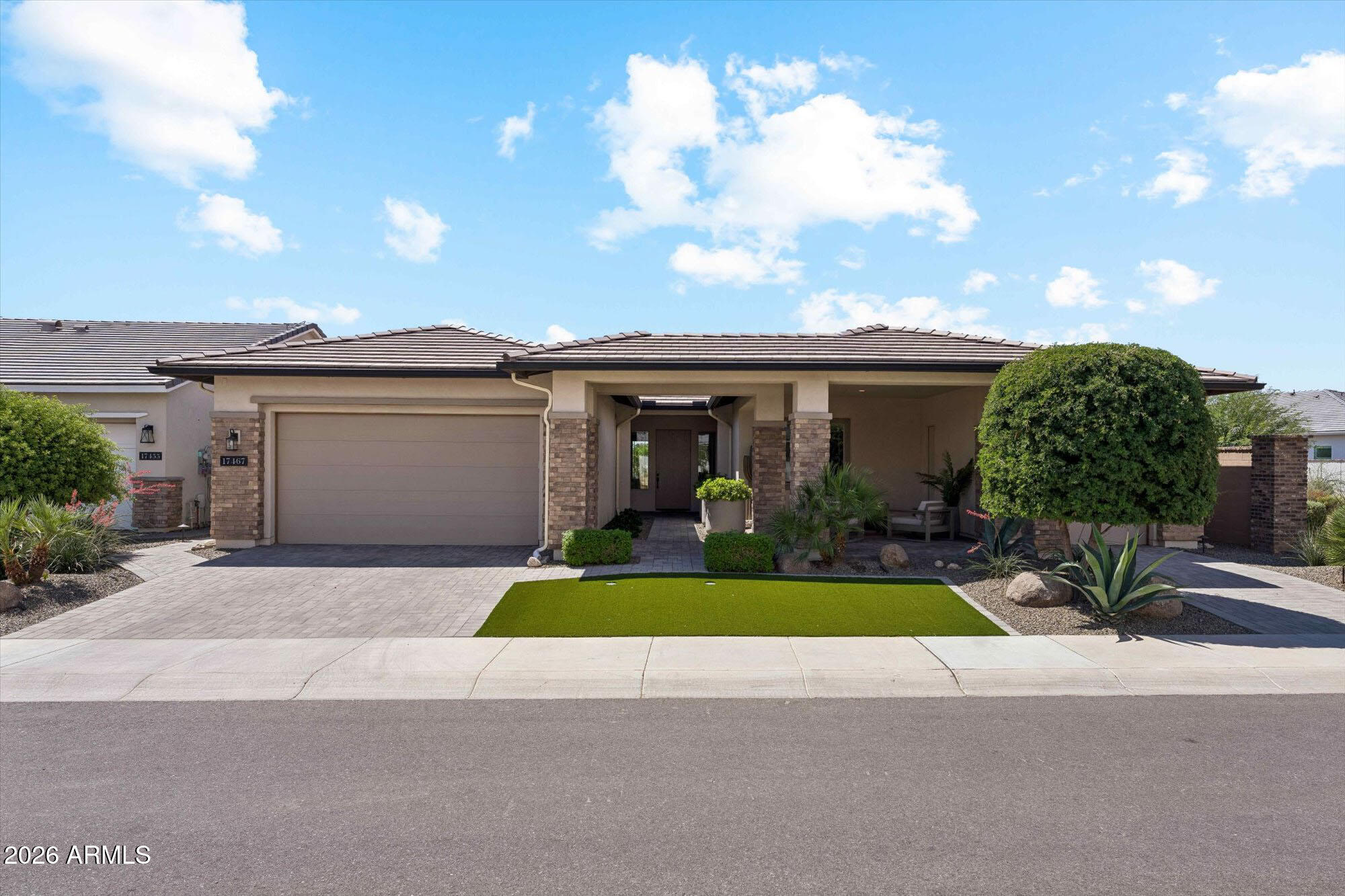 Located in the prestigious guard gated Sterling Grove Golf & Country Club, this highly upgraded 3 bed + study, 3 car garage home is ideally positioned on a premium golf course lot on Hole 12 with mountain views. Designed for elevated living, the open-concept floor plan features a 16' sliding glass wall creating seamless indoor-outdoor flow. Tile flooring throughout enhances the clean, modern design. The primary suite offers a spa-like retreat with separate his and hers closets with custom systems, and a beautifully appointed bath with tiled shower and soaking tub. Outdoor living is exceptional with a covered patio with remote-powered shades, built-in BBQ, and gas fire pit, plus a private front courtyard for entertaining. Amenities include fitness center, resort pool, golf course and more!