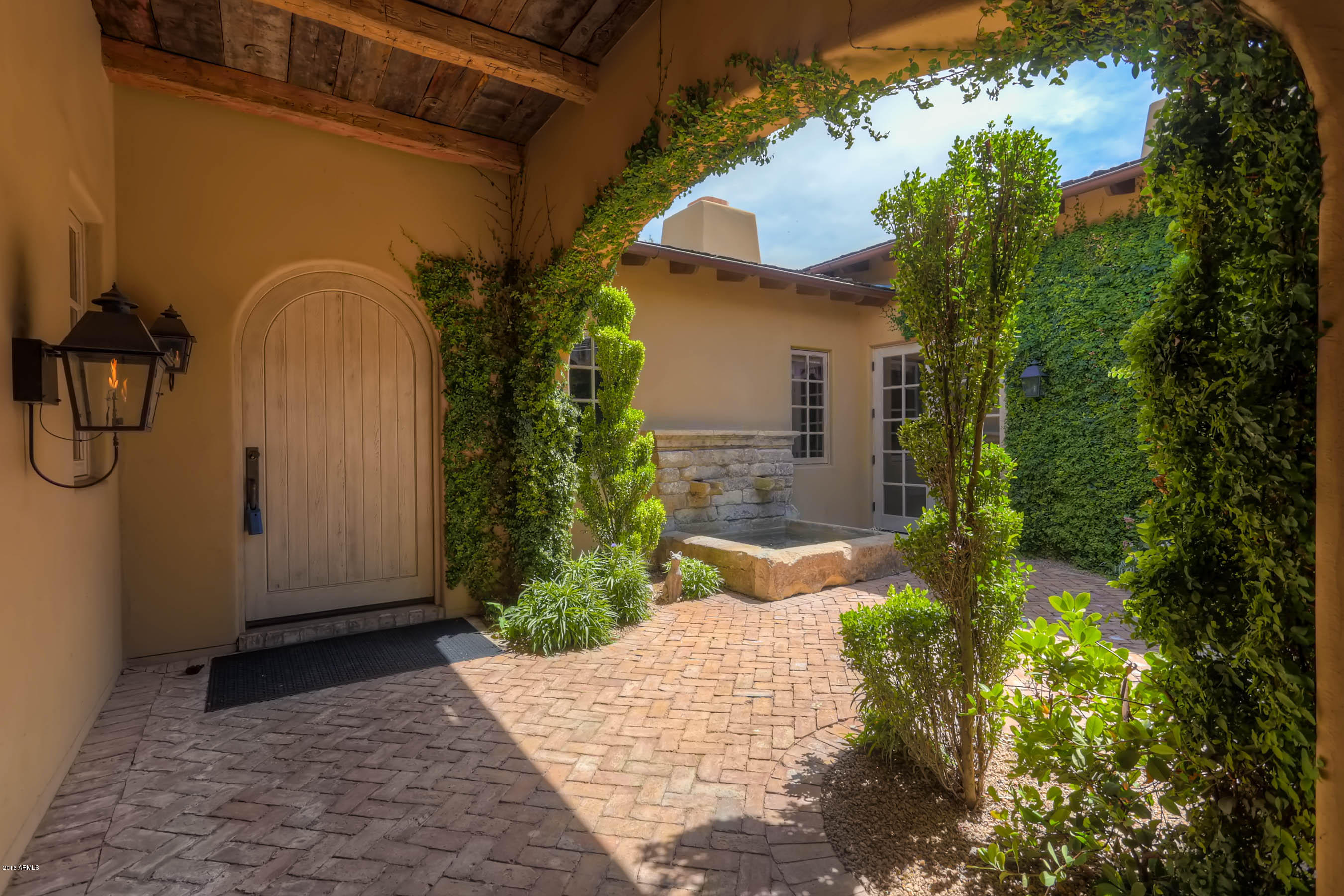 Spectacular French country home by Schultz Development, builder of the valley's finest homes, offers the ultimate in secure living at Mountain Shadow. No expense spared in this custom property. Unique features include antique beams throughout, French oak parquet flooring, hand-carved limestone, an 18th century French fountain and antique French fireplace, old Chicago brick, extensive millwork, Lacanche range, Italian Carrera marble, natural gas lanterns, zinc counter tops, wine tasting room & cellar, & spacious bistro inspired game room. Enjoy the beautiful mature olive trees on this golf course lot. Lake & mountain views from every window. Don't consider the Village at Mountain Shadows until you've seen this home. You must see the finishing touches & quality here. There's no comparison!