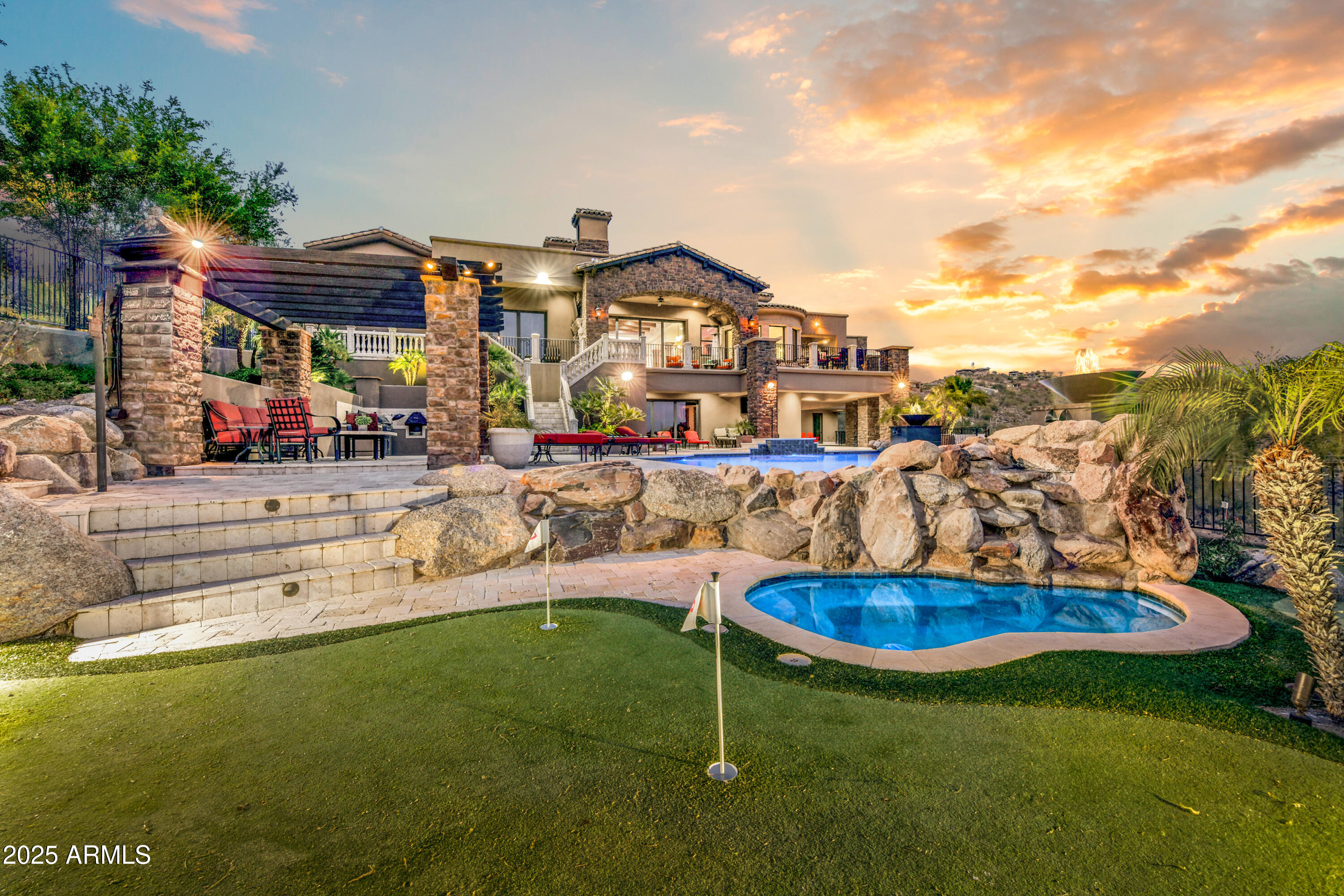Experience one of the most magnificent estates along  the Via Linda Corridor. ADJACENT 33,000 SQUARE FOOT LOT IS INCLUDED IN SALE, offering  privacy and future potential,.Enjoy breathtaking views of Camelback ,Saddleback, Mcdowell MTNS & city lights-all from the privacy of your home  5/6 Bdrms 5 full  baths, 2 half baths, blend timeless architectural elements with refined old-world charm designed to satisfy the most discerning buyer. Open floor plan with floor to ceiling windows creates an ideal setting for entertaining.
Cantera stone throughout, wood carved bar, Aquarium,  750 BOTTLE WINE CELLAR ,Exercise Room ,Media Rm, Sauna/Steam Room . Outdoor area has multiple patios,kitchen, heated  solar dive pool, Pergola, putting Green. Temp controlled 5 car garage is ideal for collectors. Home boasts Chefs Kitchen with beautiful barreled ceilings, 2 kitchen Islands, Steam oven, expresso machine, TV console, and walk in pantry.
Resort style backyard with misting systems, 2 outdoor kitchens, Green Egg, freestanding hot tub outside of Master Suite, Outdoor shower from master bathroom,  Fire Pits, cascading water fall to pool and gorgeous landscape lighting.
32 foot RV Garage