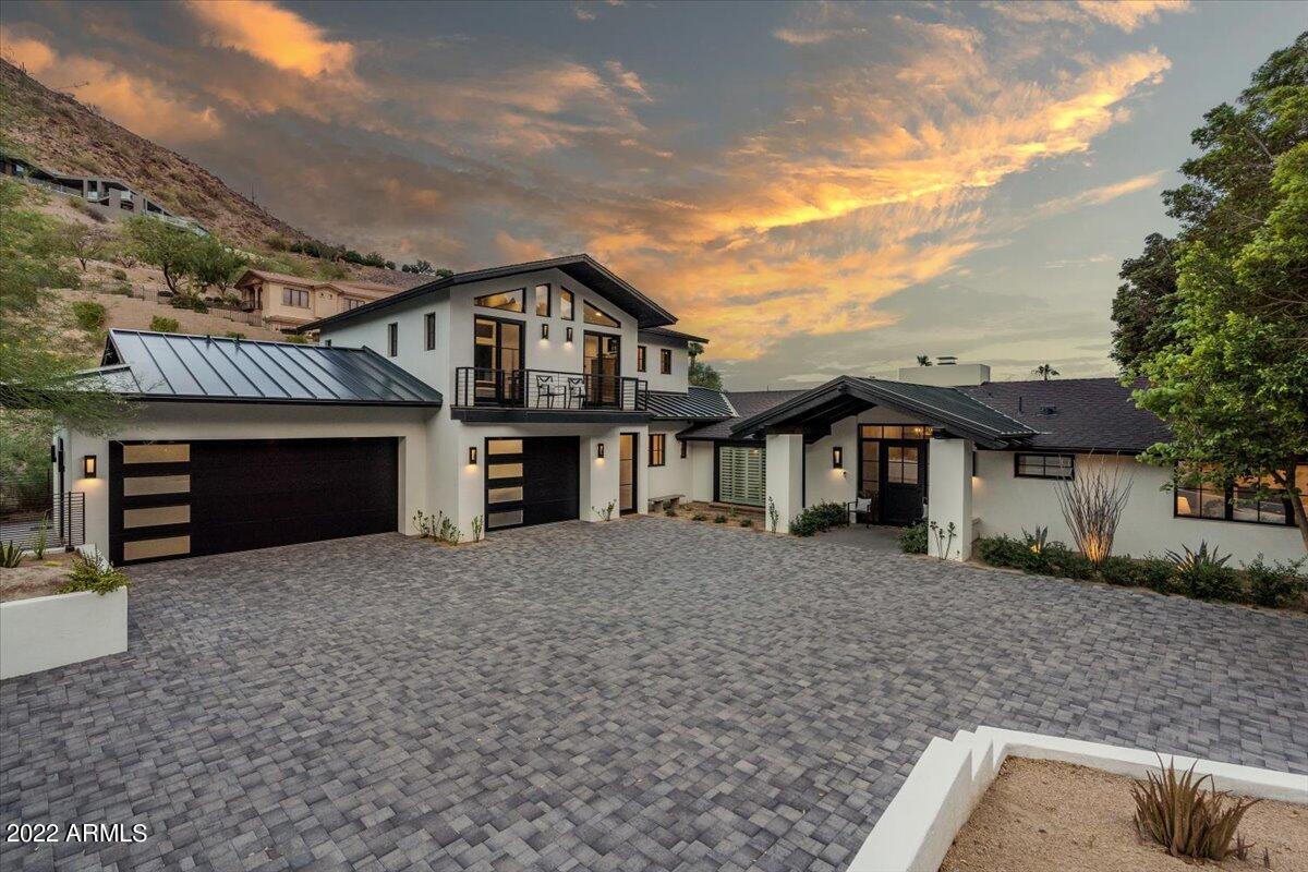 Secluded, privately gated, mostly single level home in A+ location. Four of the six bedrooms, including the primary suite are on the ground level.  Newly remodeled to the highest standard, the residence is reached via a long driveway, flanked by mature trees. The home combines the comfort and ease of casual AZ living with the luxurious custom details of the East Coast. Natural light and wood floors throughout. The chef's kitchen has marble counters and gourmet appliances.  EVERY room has a view, some w/private balconies to soak in the spectacular sunsets. Beautiful outdoor living space with sparkling pool and covered bbq entertaining area. For the car enthusiast, the meticulous 3.5 car garage is temp controlled w/plenty of storage, work areas and epoxy floors + EV Charger Note:  Wood flooring, as seen in the master bedroom, has already been purchased to match the rest of home and it is to be installed prior to close of escrow.  Sellers held off during remodel because of moving heavy furniture including a piano, extra large dining table etc.