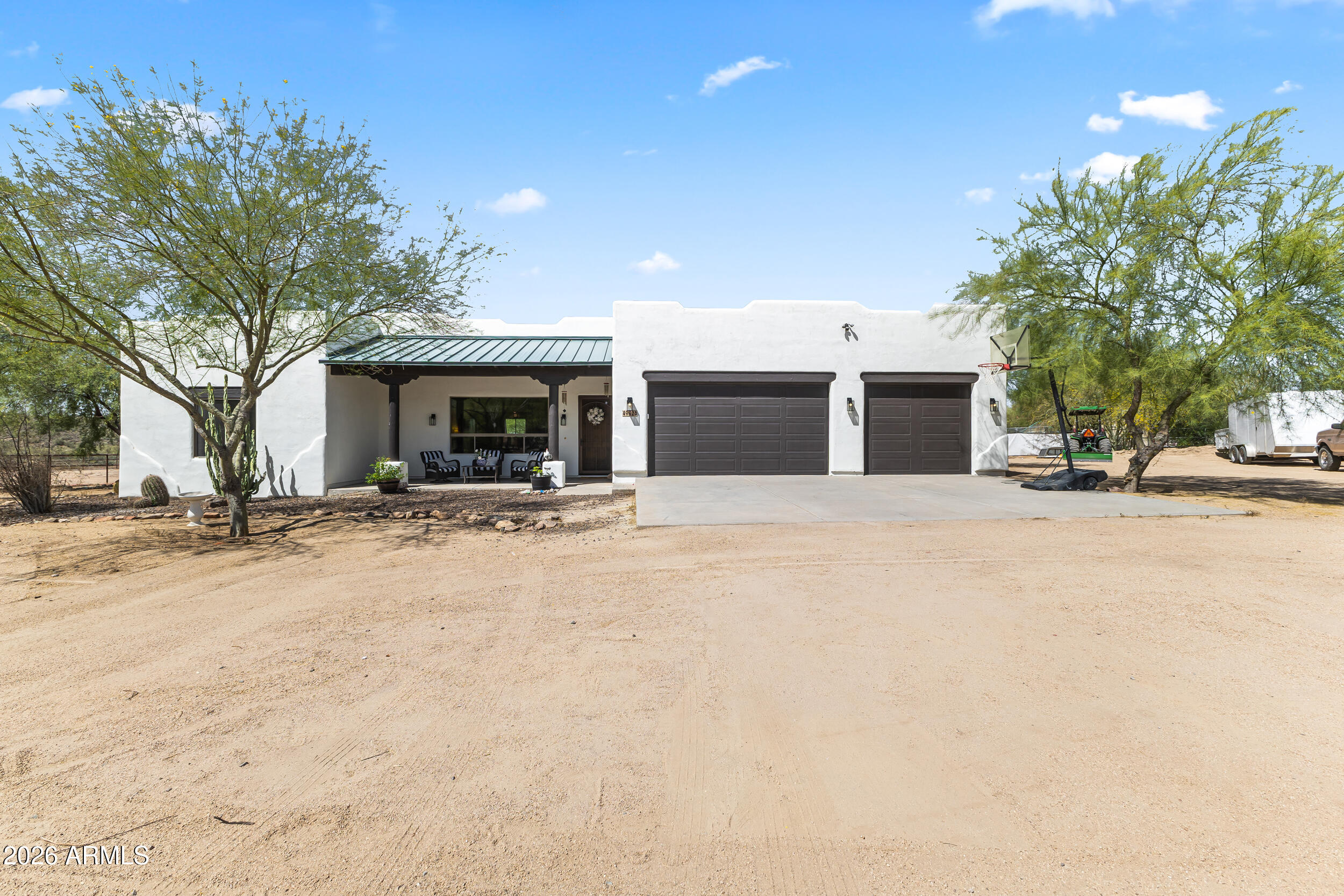 Looking for the perfect blend of comfort, privacy and Arizona desert living? Come see this beautiful home w/ 4 spacious bedrooms, 2 full baths & 30x30 3 car garage! Sitting on over an acre bordering vacant land, w/ a huge sparkling pool & spa, enjoy hiking & riding for miles & miles right from your home! With a metal roof covered patio on the front & full length covered patio in back, you can enjoy gorgeous views all day long. Tall ceilings with light paint inside & out & tons of natural light keep this home feeling bright & fresh. Custom master closet & custom cabinets & epoxy flooring in garage offer tons of extra storage. Solid wood cabinets & doors throughout the home & so many more custom touches throughout! The perfect place to enjoy quiet desert living while still close to town!