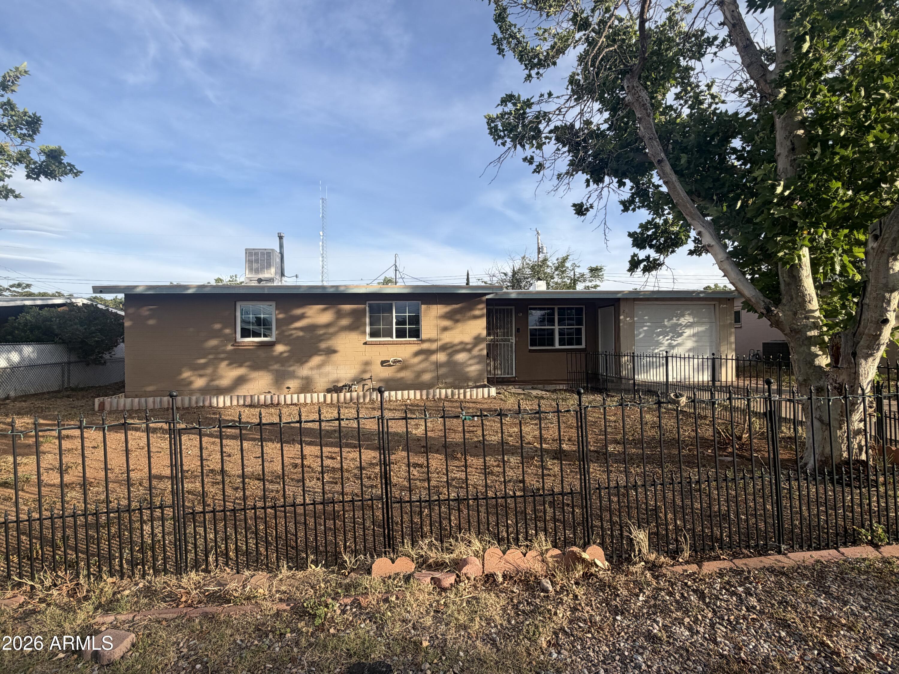 Charming single-story home with great bones and endless potential, ready for your personal touch. Situated on a spacious lot with a fully fenced front yard and mature shade tree, this property offers both privacy and outdoor possibilities. Features include a 1-car garage, extended driveway for additional parking, and a covered entry. The functional layout provides a solid foundation for updates, making it ideal for investors, renovators, or buyers looking to customize and add value. Conveniently located with easy access to nearby amenities, shopping, and major roads. Property is being sold as-is, presenting a fantastic opportunity to create something special.