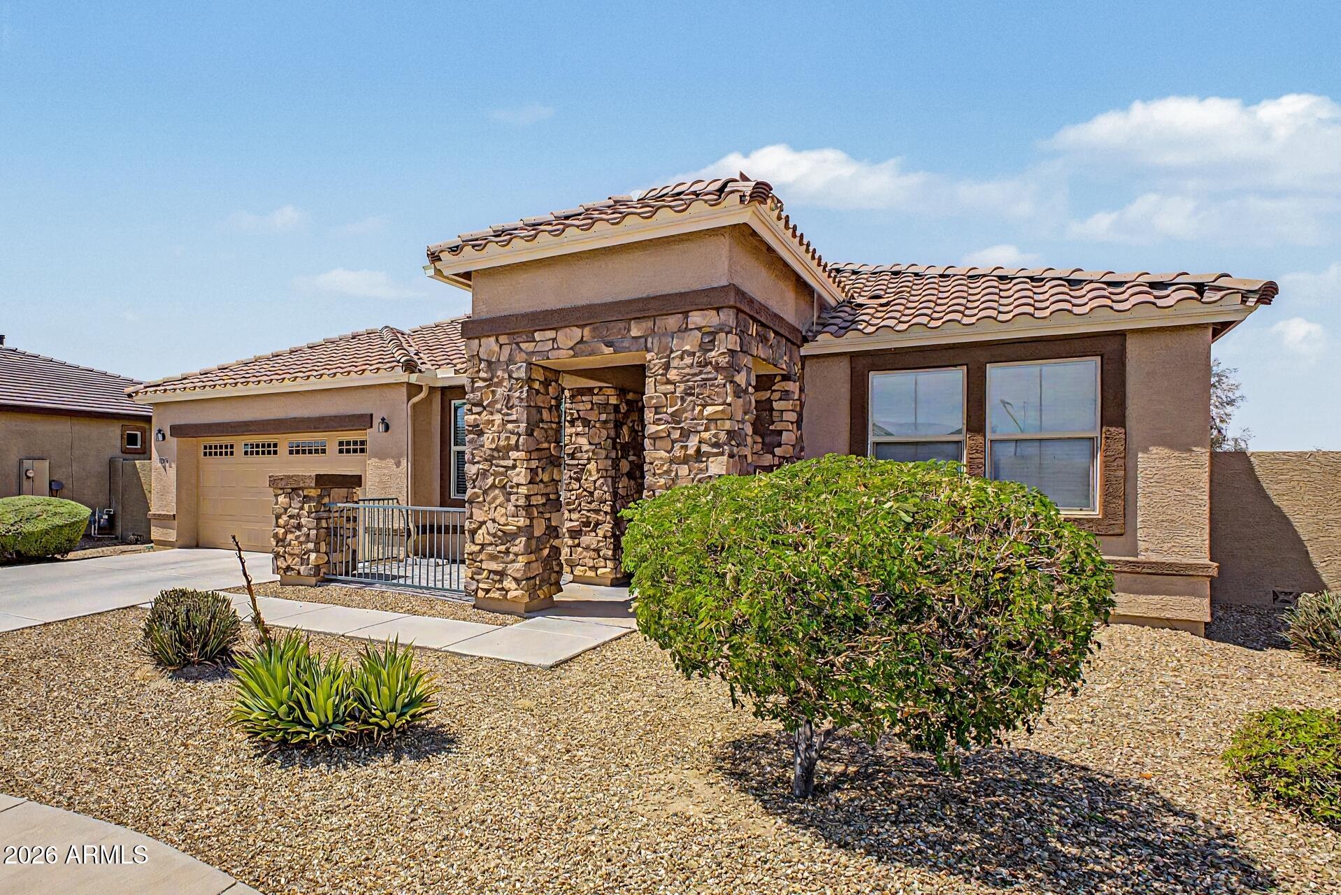 Welcome to luxury living in the highly sought-after active adult community of CantaMia at Estrella. This beautifully upgraded residence blends elegant design with everyday functionality, offering 2 bedrooms, 2 full bathrooms, and a spacious open den perfect for a home office, media room, or additional lounge space.

Designed with comfort and sophistication in mind, the bright open-concept floor plan is filled with abundant natural light, creating a warm and inviting atmosphere throughout. Enjoy a desirable no-carpet layout in the main living areas, den, and guest bedroom, featuring stylish luxury vinyl plank and tile flooring for both beauty and easy maintenance.

The expansive chef-inspired kitchen is thoughtfully designed with elegant granite countertops, abundant cabinetry, generous prep space, and a seamless flow into the living and dining areas, making it ideal for entertaining or everyday living. All appliances convey with the home.

The thoughtfully designed split floor plan offers privacy and functionality, with the spacious primary suite tucked away from the guest bedroom and den. The primary retreat features upgraded carpeting for added comfort, while the spa-like ensuite bathroom offers dual vanities and a luxurious walk-in shower. The secondary bath includes a convenient shower and tub combination.

Additional highlights include exceptional storage throughout, a built-in workspace with upper and lower cabinetry ideal for remote work or organization, plus added cabinetry in the laundry room for enhanced functionality.

Step outside and enjoy Arizona living at its finest. The oversized covered backyard patio with stylish pavers creates the perfect setting for entertaining, relaxing, or enjoying peaceful evenings outdoors. A charming covered front patio offers the ideal spot to enjoy your morning coffee.

Experience the unmatched resort-style lifestyle that CantaMia at Estrella has to offer. Residents enjoy access to the impressive 29,000-square-foot Village Center, a state-of-the-art fitness center, indoor lap pool, outdoor resort-style pool, stocked lakes for catch-and-release fishing, tennis, pickleball, bocce ball, billiards, art classes, cooking classes, and an abundance of social and recreational activities.

Discover the perfect blend of luxury, comfort, and vibrant community living. Your next chapter begins here.