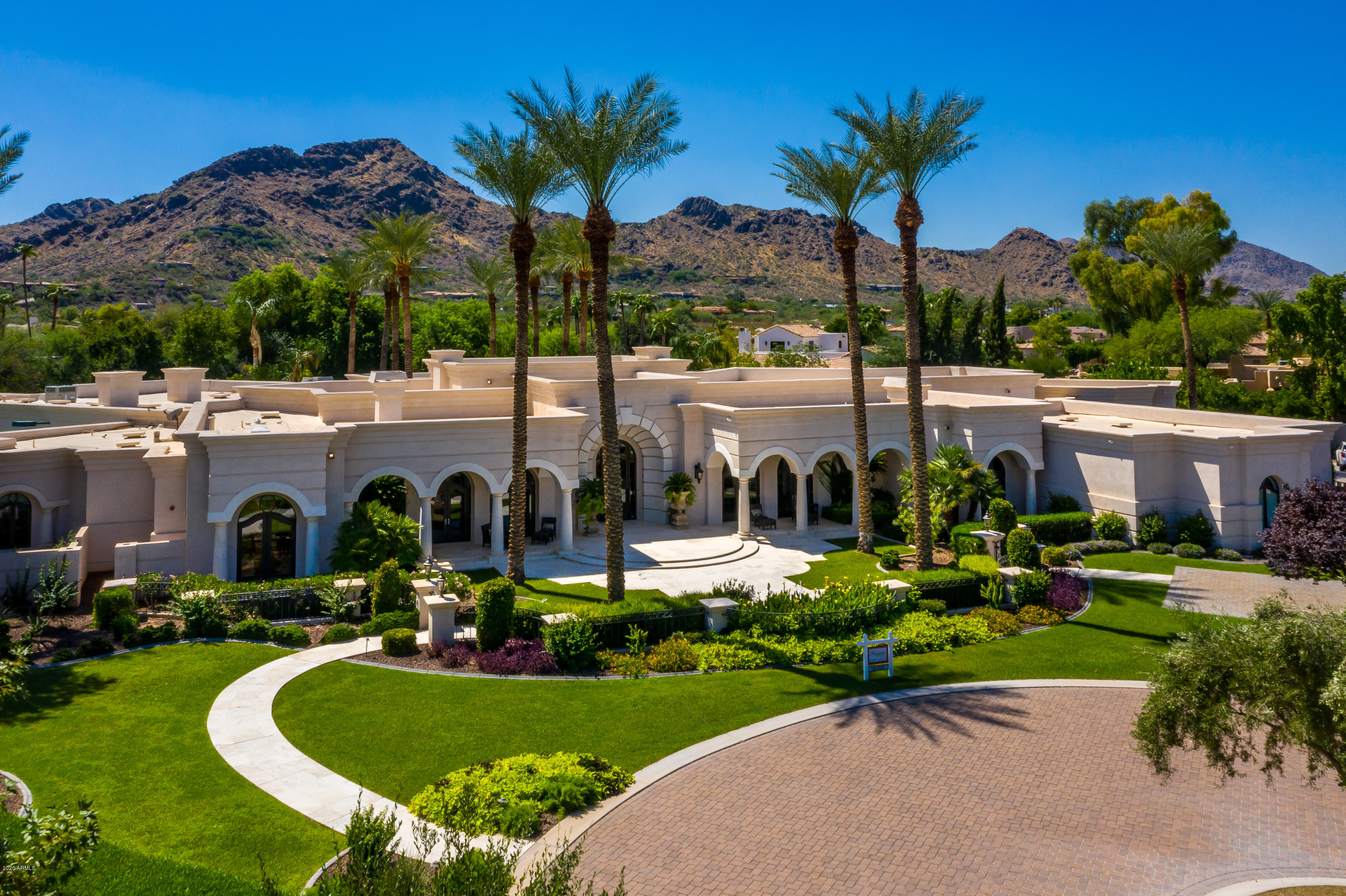 The very essence of LUXURY! Nestled in the exclusive VILLARESI enclave of Paradise Valley. Mediterranean opulent resort-style living on private lush 1.8 acre lot. Exquisite 13,000sqft single level home featuring 7 bedrooms, 12 bathrooms, including 2 guest homes! Expansive 25ft disappearing glass wall leading you to the impeccable grounds! Outdoors is an entertainers paradise showcasing a grand 50ft palm tree lined pool, sunken lit tennis court, fountains and meandering walkways for pure enjoyment in the lap of luxury!