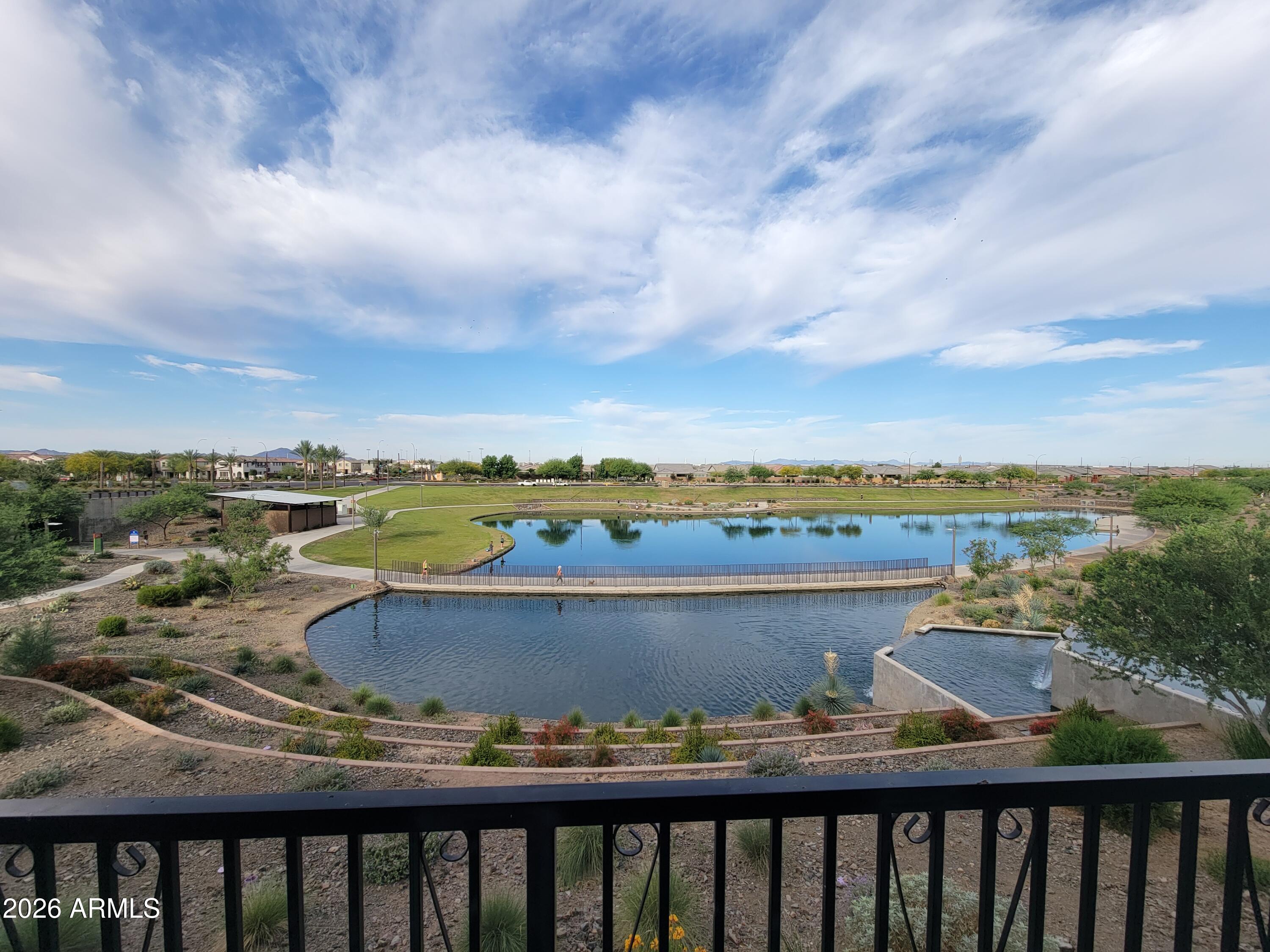 Rare opportunity to own one of the few homes in Eastmark with beautiful lake views! This exceptional 3-bedroom, 2-bath townhome offers a premium location with peaceful water views that can be enjoyed from both the inviting front porch and the private balcony.

Inside, you'll find an upgraded kitchen featuring granite countertops, upgraded cabinetry, and ample storage, making it as functional as it is attractive. Custom wood-look tile flooring adds warmth, style, and durability throughout the home's living spaces. The open and inviting floor plan is filled with natural light and designed for comfortable everyday living.

Adding to its appeal, this home includes a private driveway--an uncommon feature that sets it apart from many other townhomes in the community. Combining low-maintenanc living, desirable upgrades, rare lake views, and all the amenities that Eastmark has to offer, this is a truly unique opportunity you won't want to miss