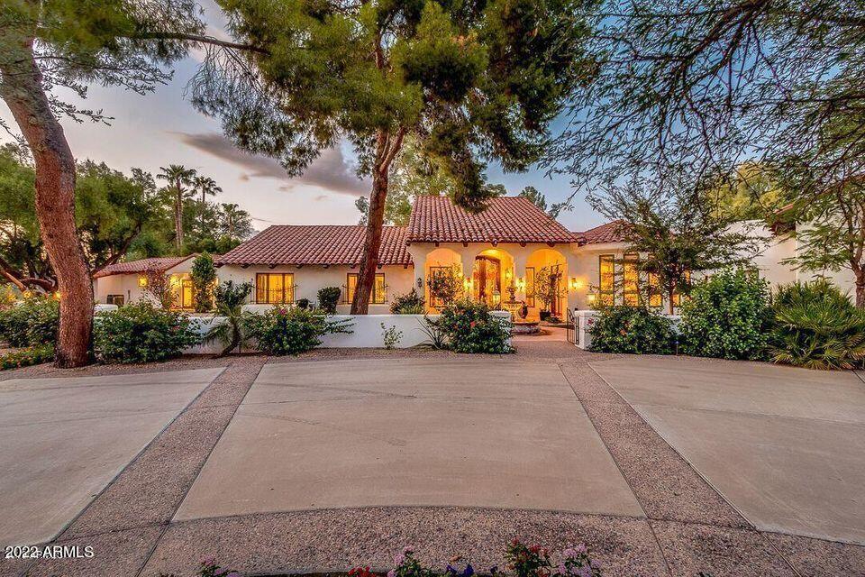 Beautiful family home in a perfect location close to Paradise Valley and Scottsdale amenities. This  magnificent Santa Barbara style home is on a 1.2 acre golf course corner lot virtually surrounded by serene golf course views. Very private. Set in a beautiful neighborhood with mature, easy to maintain landscape the custom home split floor plan includes a Master bdrm wing with adjacent library & gym. Master bath comes complete with jacuzzi tub and dry sauna. The grand 10' glass & wrought iron entry opens to an amazing great room with beamed 20' ceilings, resort style fireplace & expansive backyard views to the golf course & newly renovated pool. Enjoy the chef's kitchen with huge natural quartzite island & Dacor, Kitchenaide & Subzero appliances, elegant Rysso-Peters cabinets. Huge walk in pantry. West wing is fully connected yet has separate guest entry to 2nd Living Room, kitchen, 2nd Master bdrm with full bath. Separate second Gigablast WIFI system allows for ample work from home capability. Massive garage with epoxy flooring and new cabinetry with storage galore. The neighborhood is unequaled for quiet, safety and walkability. stroll the golf course after hours as a private park! NO HOA.