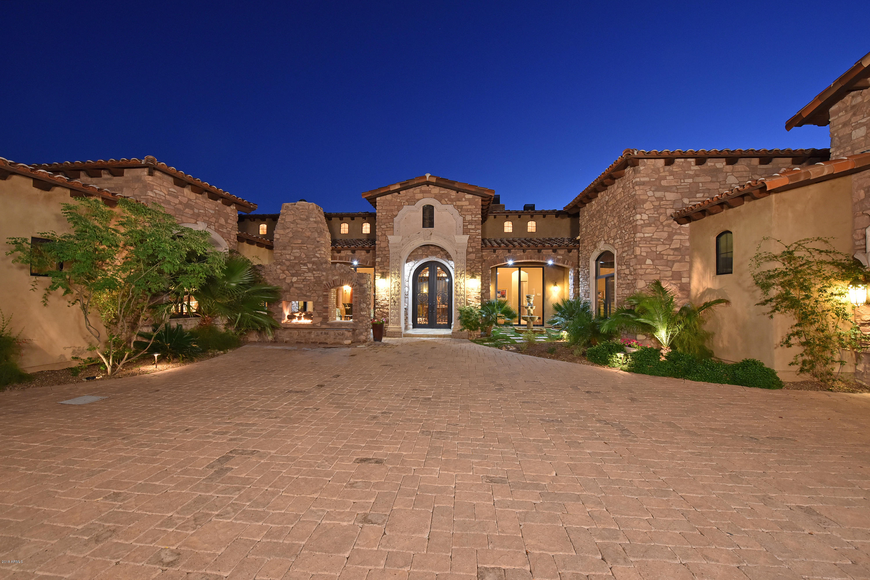SINGLE STORY MOUNTAIN SIDE HOME IN ANCALA! AMAZING OPPORTUNITY! City lights & CAMELBACK VIEWS! As you enter the courtyard you will experience a sense of cultural AWE! Phenomenal architecture, master craftsmanship, superior use of stone, cantera & wood beams, barrel & groin ceilings & handcrafted millwork thru out, exceed all expectations! Enjoy 8000 Sq.Ft. that includes: Formal living & dining rms, Study w/built-ins, game rm w/wet bar, 2 tier theater & luxurious master suite. Don't miss the GOURMET KITCHEN designed for the ultimate in entertaining. The GUEST CASITA is a home away from home. You will be enticed outside on the expansive multiple covered patios, 2 exterior fireplaces, 2 tiered backyd w/negative edge pool,spa, CITY LIGHTS & MT. VIEWS. READ MORE & SEE DOC TAB FOR INFO. This home has unparalleled finishes, flowing floor plan and breath taking VIEWS.  The split floor plan along with the casita provides flexible living space for your life style needs.  The casita has its own living room, kitchen, master suite, a luxurious bath and walk-in closet.  
   The gated entry creates total security and privacy.  Need garages? This home can accommodate 5 cars and has a large motor court.  
  YOU MUST SEE THIS HOME TO APPRECIATE WHAT IT HAS TO OFFER.