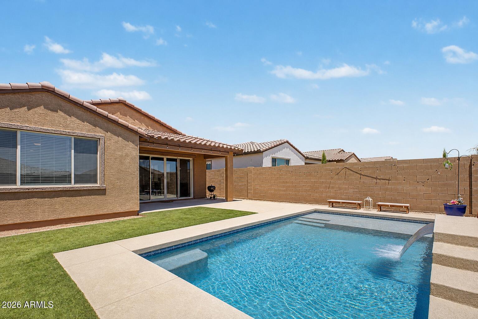 Beautiful single-level home in Peralta Canyon featuring a spacious open-concept floorplan with 4 bedrooms and 2 bathrooms. This popular layout offers a split primary suite, generous great room, and an open kitchen perfect for entertaining. The kitchen showcases stylish countertops, designer backsplash, upgraded cabinetry, stainless steel appliances, and a large island with seating.

Additional features include tile flooring in main living areas, tankless hot water heater, dual pane windows, ceiling fans, and abundant natural light throughout. The exterior offers attractive curb appeal with stone accents and a welcoming front elevation.

The private primary suite features a walk-in closet and oversized bathroom with dual sinks and walk-in shower. Enjoy all that Peralta Canyon has to offer including walking paths, parks, and stunning Superstition Mountain views.
