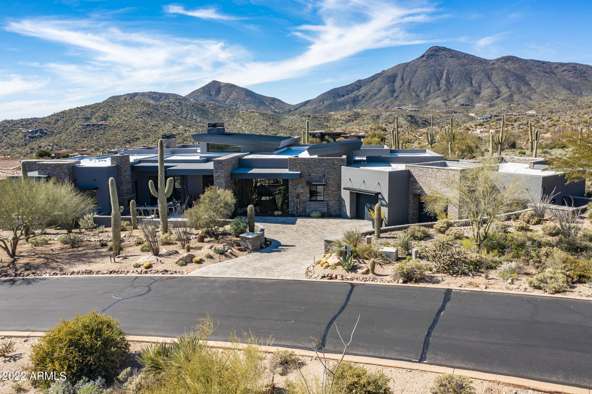 STUNNING contemporary in Desert Mountain complete with a Full transferable Golf Membership (see info under documents tab).  Every window in this home is perfectly placed to frame the mountain views outside.  The straight structural lines plus the wood accents makes this a warm contemporary at its finest.  Set off by incredible decor (avail separate bill of sale) all you need to do is bring your clothes and move right in and live the resort life. The kitchen offers all of the latest bells and whistles from the La Cornue French range, Wolf steam oven, dual subzero refrigerators, wet bar, dual islands with Carrara marble with waterfall edge.  Push open the wall of glass and truly enjoy the AZ indoor/outdoor living.  (con't) Four beautifully appointed en-suite bedrooms, plenty of room for everyone. Don't miss this one as it won't last long
Day back on the market 3/15.