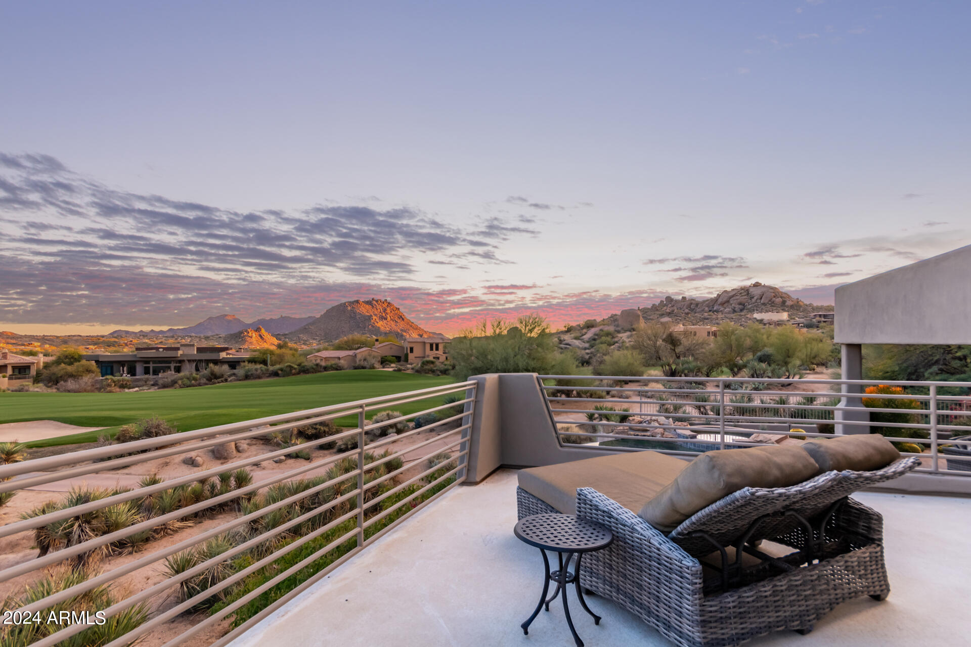 Gorgeous golf property located on the 14th hole of Troon North Monument course, within the prestigious gated community of Pinnacle Canyon. Stunning panoramic mountain views capture both the sunrise over Four Peaks to the east and sunset over Troon Mountain to the west. With an oversized pocket door that opens to the exterior living space, you'll have the ultimate in indoor /outdoor living. The open floor plan creates a spacious and inviting atmosphere, with a dual sided LED fireplace to warm both the living room and dining area.  The remodeled large chef's kitchen features an abundance of cabinetry and top-of-the-line Thermador appliances. Luxury amenities include a climate-controlled wine cellar and theater room with 130-inch screen. New tile and PVC 80 mil vinyl roof. Newer Central Vac. The primary bedroom features a private deck, sitting area, and luxurious bathroom with spacious double walk-in closets and soaking tub. The home features a fourth bedroom (attached ensuite casita) suitable for use as a bedroom, office or gym. Situated on a cul-de-sac, you'll have the best of both privacy and views.
