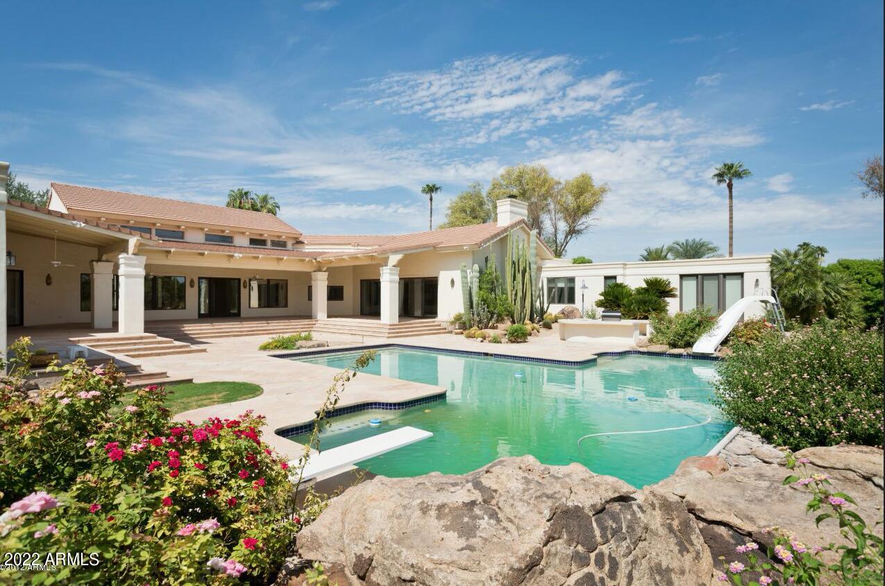 Fabulous elegant Santa Barbara style single level custom home in this highly desired Camelback Country Estates enclave.  Awesome curb appeal, incredible quiet, tucked away location, & a  terrific resort style backyard--this is a stunning home that will call to you!  This custom estate features an awesome split floor plan, soaring high ceilings through out the home & incredible living spaces with a huge chef's kitchen that opens to a huge family room & spacious breakfast nook/in the kitchen. The primary suite is fabulous & features a huge primary bathroom with sep. tub and walk-in shower + generous cabinet space & double sinks. & sep. HIS/HER closets.  Steps away from the  primary suite is the large beautiful Black Forest Walnut wood paneled office.
The main living area of the home is perfect for entertaining friends & everyday living with the impressive Mahogany wood front door, stunning formal living & dining rooms with walls of glass overlooking the incredible backyard, huge chef's kitchen, huge family room & secondary bedrooms all in the same wing of the home. Attached guest quarters has separate entry for privacy for your over night guests! The resort style backyard features a fabulous diving pool with a separate fun zone area w/ slide & a large play pool area! Dream backyard with a sport court tucked away in the corner of the backyard too!