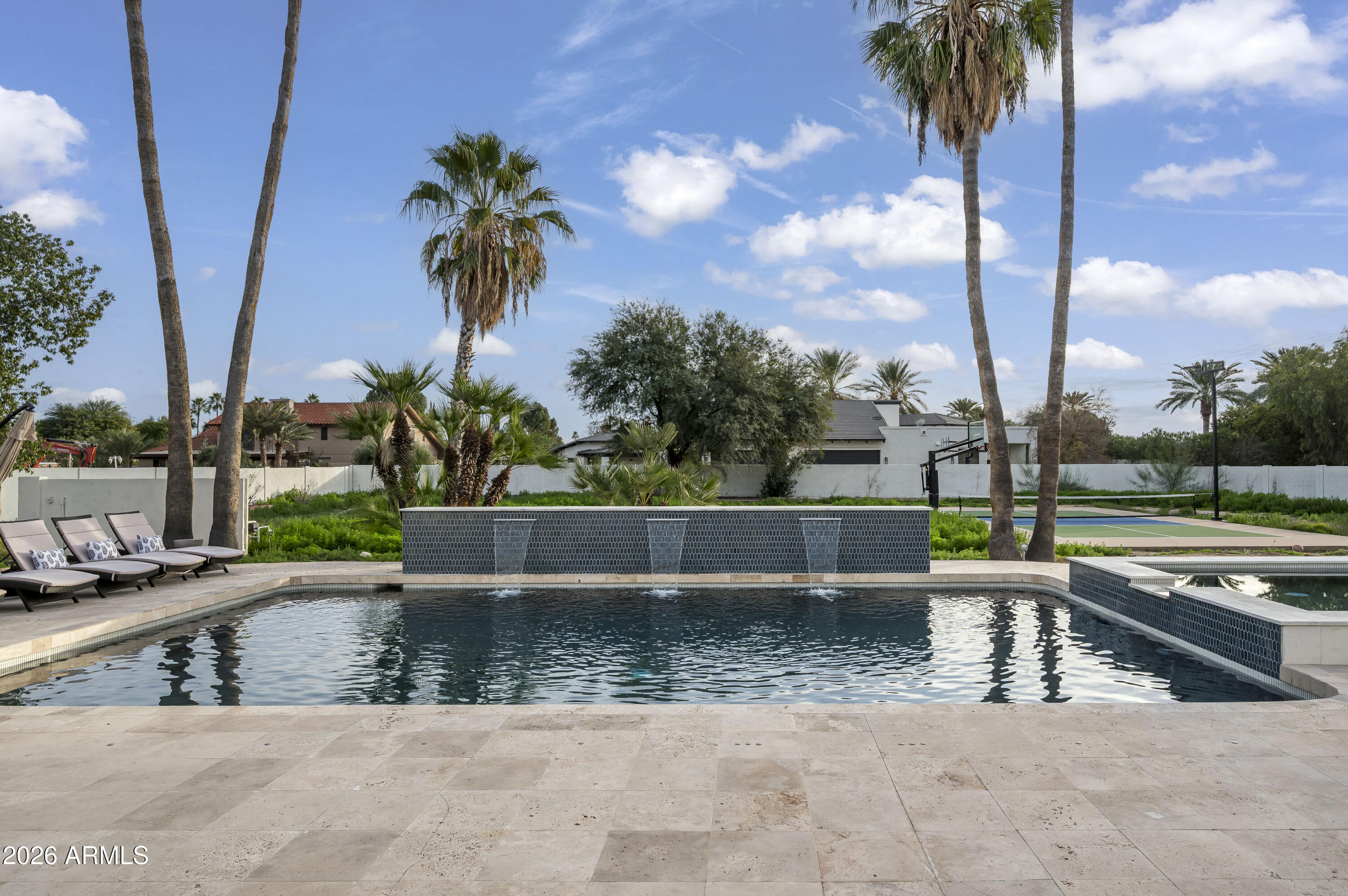 Fully renovated residence with 7-car garage in Scottsdale's coveted Cactus Corridor. This reimagined property blends modern sophistication with timeless design, showcasing McDowell Mountain views, a grand entry, soaring ceilings, and expansive windows that flood the home with natural light. The open-concept great room features a statement fireplace and seamless indoor-outdoor living. A chef's kitchen impresses with waterfall quartz countertops, custom cabinetry, and premium Café appliances. The split floor plan offers private guest quarters and an oversized entertainment room. The oversized lot has a refinished pool and sport court with plenty of room to add. Over-height garage with workshop is a rare opportunity.