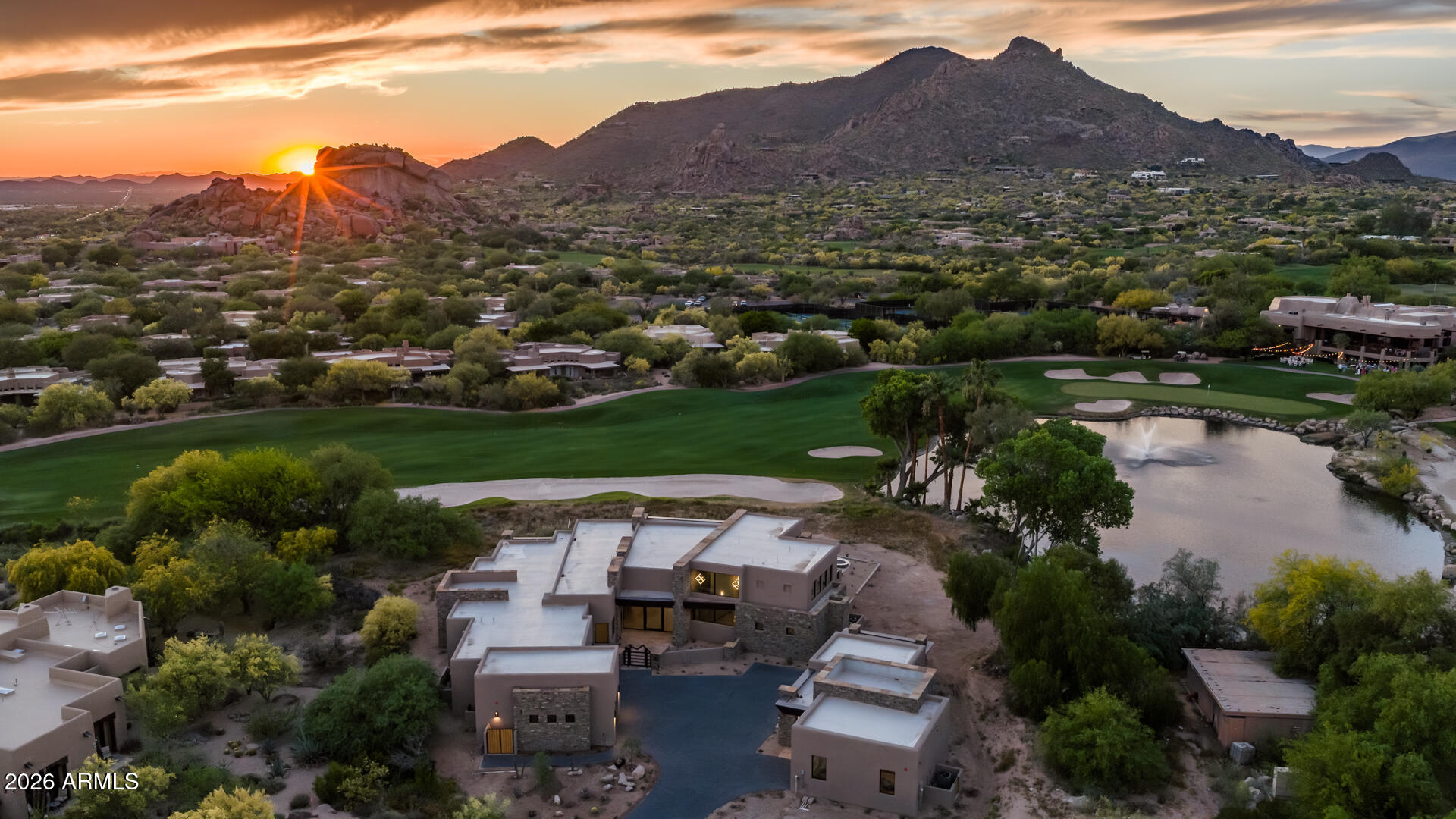 A rare opportunity to own The Jewel of the Boulders, set on over 1.1 acres along the iconic 18th hole of both the North and South courses. This privately gated, newly built luxury home offers over 7,000 sq ft of living space with sweeping mountain, golf course, water, and clubhouse views. Features include a chef's kitchen with multiple Sub-Zero and Wolf appliances, temperature-controlled wine room, whole-home automation, and a serene primary suite with steam shower and custom closet. Guests enjoy en-suite bedrooms, a secondary primary suite, and a detached casita with its own bedroom, bathroom, kitchen, great room, private patio, and cooled one-car garage. The upper level includes two bonus rooms accessible by stairs or elevator, with two private patios, a kitchen, built-ins, and elevated views of the course, mountains, and water. The property includes 5 cooled garage spaces, a car lover's dream. Outdoors, a negative-edge pool, fire features, and full outdoor kitchen overlook Black Mountain. Located in the Reserve at The Boulders with access to world-class golf, spa, fitness, tennis, pickleball, and hiking.