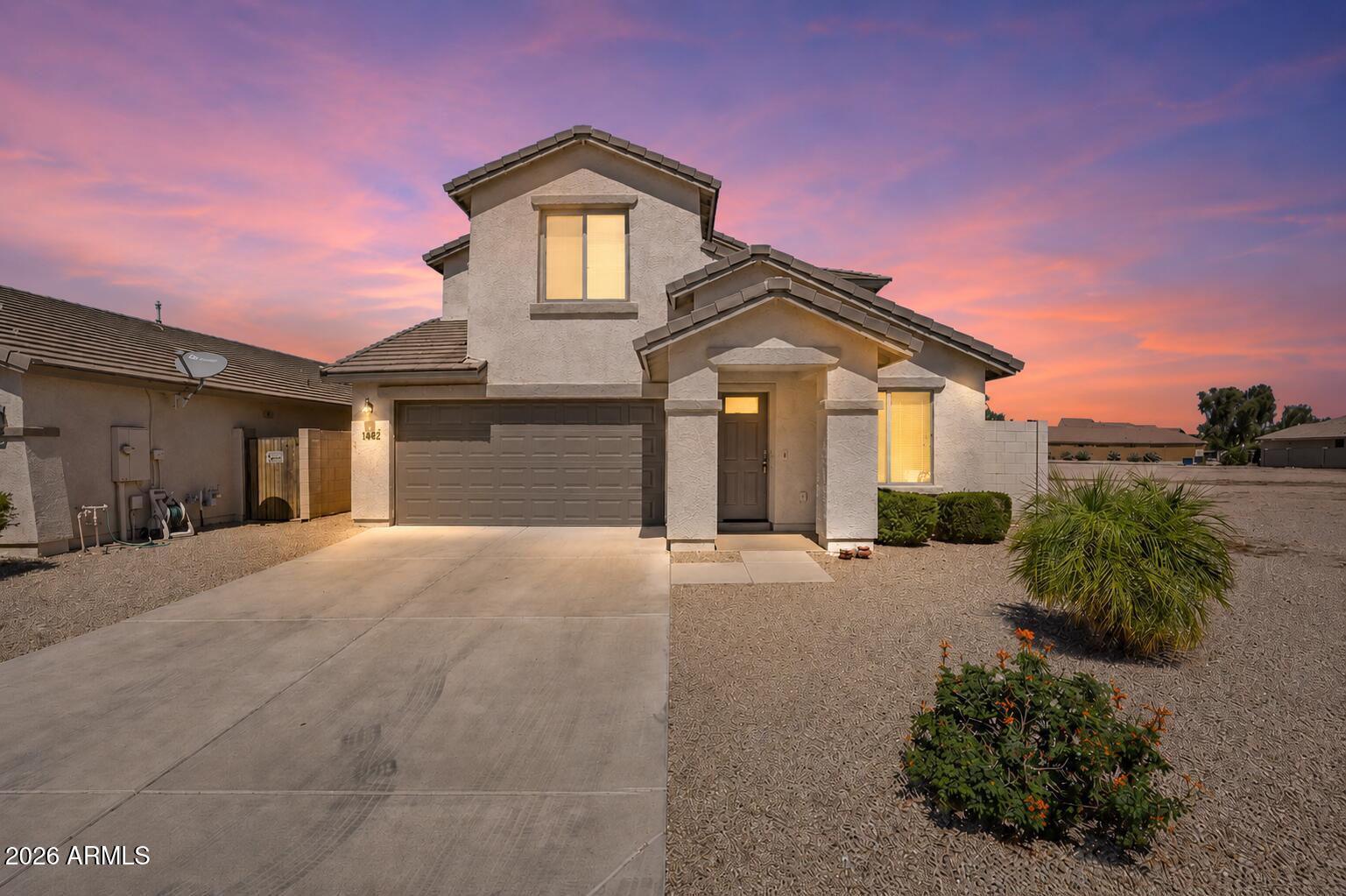 This Heartland Ranch home offers something that's surprisingly hard to find in Coolidge- A true 2-story layout with the primary suite downstairs and four generously sized bedrooms upstairs. Built in 2016, the home feels newer than many resale options. The kitchen features stainless steel appliances, recessed lighting, a large island with breakfast bar, and an open flow into the main living space. The downstairs primary suite offers privacy away from the upstairs bedrooms and includes dual vanities, a walk-in shower, private water closet, and oversized walk-in closet. Upstairs, the additional bedrooms are larger than what you'll typically find in similar homes, plus there's a versatile loft/flex space and full laundry room. Outside, the backyard is already finished and ready to enjoy with artificial turf, pavers, and a full-length covered patio perfect for relaxing or entertaining. With no neighbors behind you and only one direct side neighbor, this property offers a level of privacy that's difficult to come by in subdivision living.