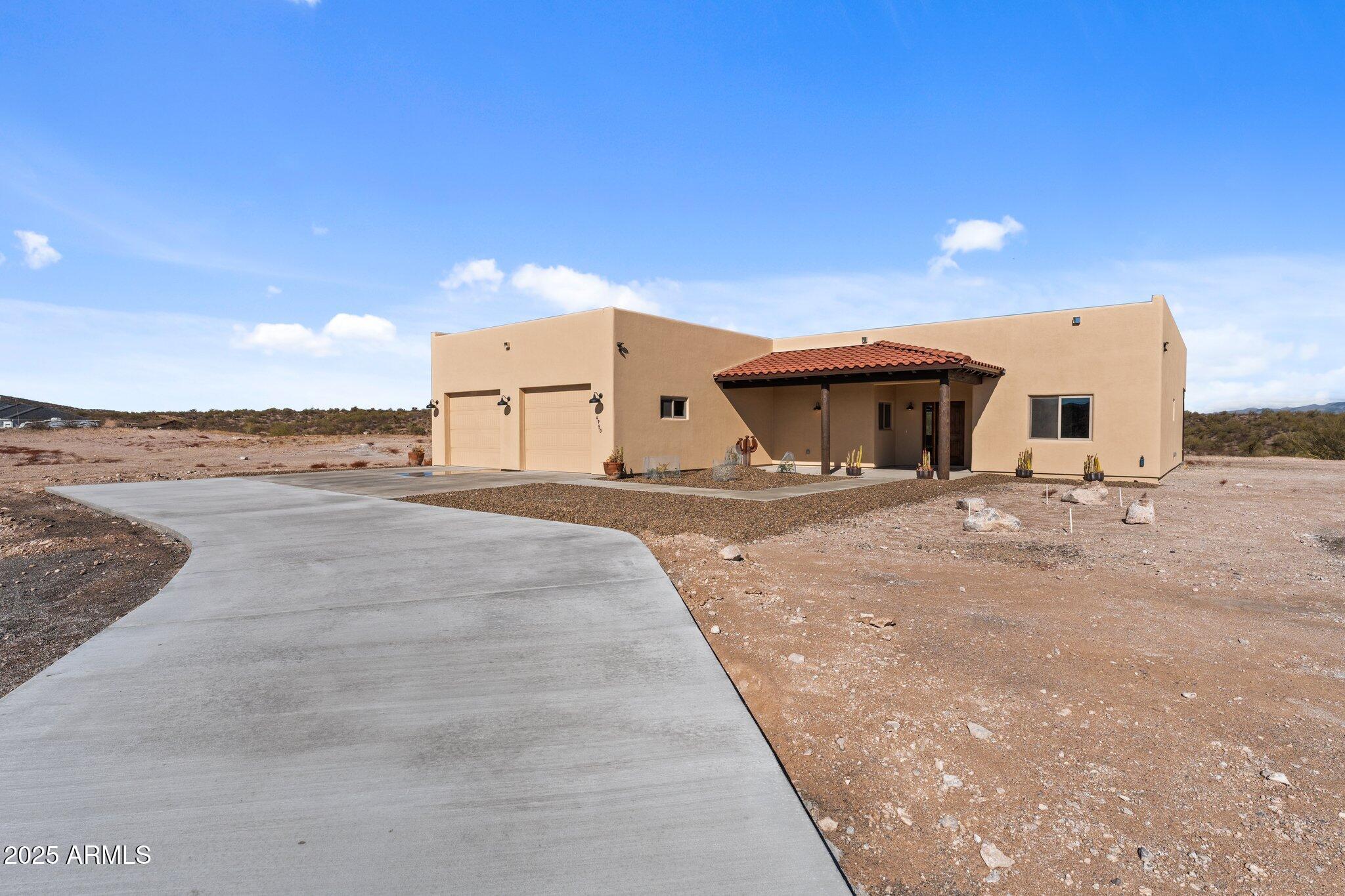 Welcome to Your Dream Santa Fe Style Home in Wickenburg, Arizona's Black Mountain Ranches! Enjoy the luxury of space on your vast 4.7-acre lot! With unobstructed views of the open desert and majestic mountains, this residence is a true oasis of tranquility and beauty. Step into luxury as you enter this custom Rubash home, where every detail has been meticulously crafted to perfection. The spacious and open floor plan boasts a plethora of upgrades, promising a lifestyle of utmost comfort and elegance. Throughout the home, you'll find wood-style tile floors that exude warmth and character. These floors not only add to the aesthetic appeal but also ensure easy maintenance, combining style with practicality. Concrete driveway was installed 2025.