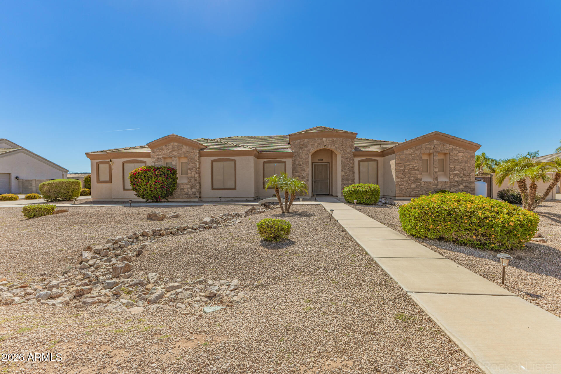 Rare opportunity to own a 1.26-acre property with NO HOA in San Tan Valley! Enjoy the freedom and space buyers are searching for with plenty of room for RVs, trailers, toys, animals, or future projects. This spacious home features 4 bedrooms and 3.5 bathrooms, plus a formal living room and formal dining room ideal for entertaining. The open floor plan offers 12' ceilings in the main living area, creating a bright and inviting space that flows into the large kitchen with oversized island. The primary suite includes separate walk-in closets and the home offers excellent storage throughout. A 3-car garage provides additional room for vehicles, hobbies, or a workshop. Peaceful desert living while still minutes from shopping, dining, and amenities.