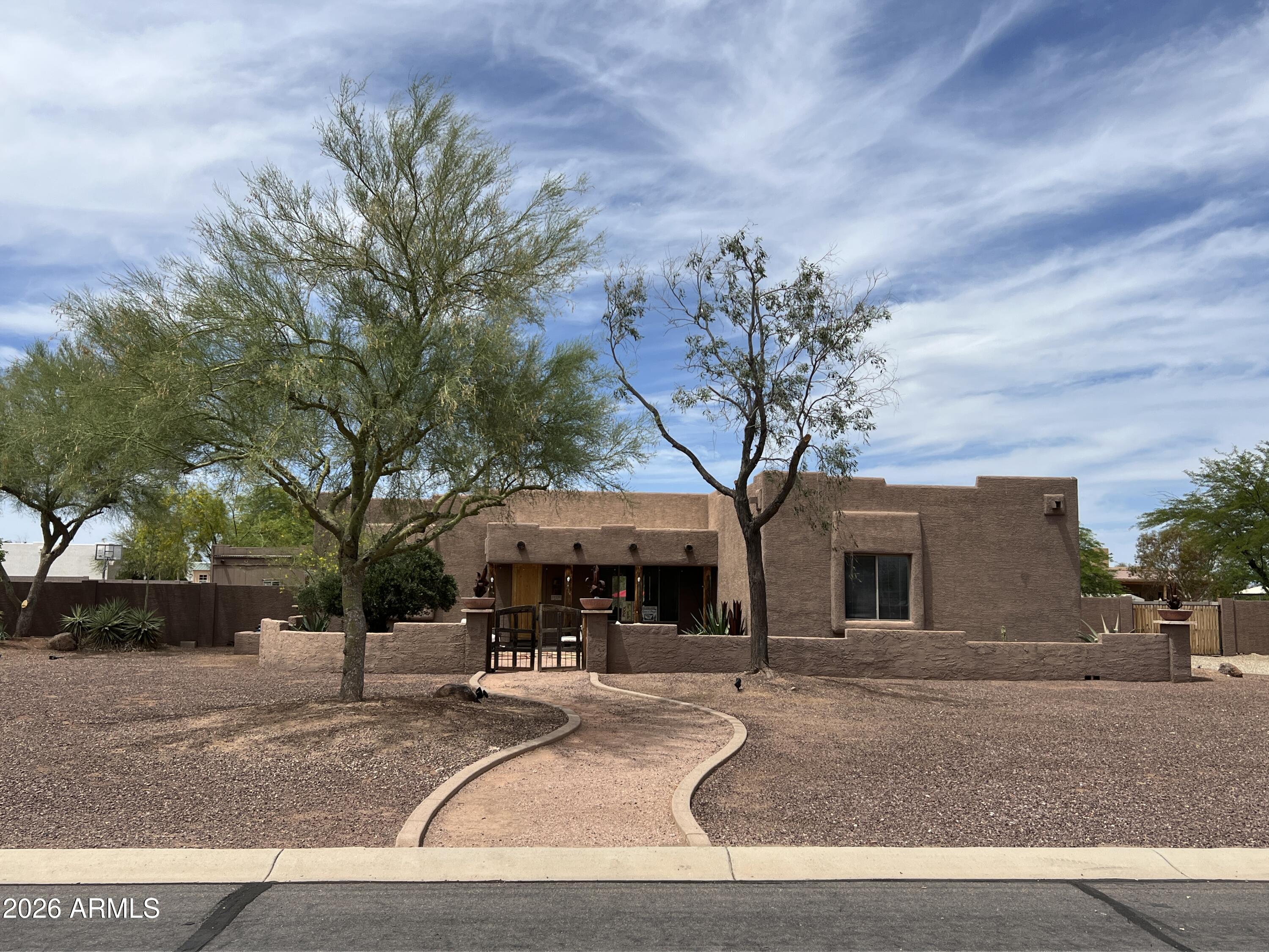 THIS IS A RARE OPPORTUNITY TO BUY IN PATTON PLACE ESTATES. THIS 4 BED 2 BATH 2160 SQ FOOT SOUTHWESTERN STYLE HOME  IS OFFERED BY THE OIRIGINAL OWNERS ESTATE. IT IS  SET ON ONE ACRE THAT'S FENCED WITH A BLOCK WALL . HORSES ARE ALLOWED !!AS YOU ENTER THE FRONT GATE THERE IS A WALLED COURTYARD WITH A  POND AND DESERT LANDSCAPING.  YOU STEP INTO A HOME  FULL OF CUSTOM UNIQUE CHARM. THE HUGE  CUSTOM STONE FIREPLACE WITH A SITTING HEARTH GREETS YOU AS YOU ENTER THE SPACIOUS GREAT ROOM. THE KITCHEN, DINING & LIVING ARE  AN OPEN AREA FULL OF NATURAL LIGHT AND COMFORT.  THE KITCHEN IS OPEN WITH  A  HUGE  ISLAND, CUSTOM CONCRETE COUNTERS. WHITE CABINETS, INDUSTRIAL WOOD AND METAL SHELVES. THE  LARGE SKYLIGHT ADDS TO THE CHARM. & NATURAL LIGHT . 2 PANTRIES & FARM SINK. A NEW FRENCH DOOR FRIDGE, A WINE FRIDGE AND ELECTIRC STOVE. THE HUGE KITCHEN HAS AN EAT-IN SPACE AND  THERE IS ROOM FOR A DINING AREA TOO IN THE GREAT ROOM. THE CEILING ARE  10  FLAT CEILINGS FOR A MODERN SPACIOUS FEEL. THE LARGE WINDOWS LOOK OUT TO THE DESERT BACKYARD AND COVERED PATIO AND POOL. THE  SPACIOUS MAIN SUITE  & BATH ARE SEPERATED BY A BARN DOOR. THERE IS A LARGE WALKIN CLOSET WITH SHOE STORAGE, A SOAKER TUB AND SEPERATE SHOWER AND DOUBLE SINKS. THE POTTY ROOM IS PRIVATE & THERE IS AN EXIT TO THE EXPANSIVE COVERED PATIO AND POOL AREA. THE INSIDE LAUNDRY INCLUDES WASHER AND DRYER AND OVERHEAD STORAGE. THE OTHER 3 BEDROOMS AND MAIN BATH ARE ON THE OPPOSITE SIDE OF THE HOME. ONE ROOM IS USED AS AN OFFICE THAT HAS FRENCH DOORS. THERE IS  A FULL BATH WITH A LINEN CLOSET TOO! THE BACK BEDROOM HAS FRENCH DOORS TO THE BACK PATIO AREA.
OUTSIDE THERE IS A DETACHED STORAGE BUILDING & 2 GAZEBOS. THE  PROPERTY HAS AN UPSCALE  SOUTHWESTERN VIBE TO THE  OUTSIDE. THE DESERT LANDSCAPING IS LOW MAINTANENCE  DESERT LANDSCAPING WIHT TREES TOO. THE HOME HAS A STUCCO EXTERIOR AND RV GATE. THERE IS A 3 CAR GARAGE THAT WAS CONVERTED TO AN ART STUDIO AND METAL SHOP. IT IS NOW FRESHLY PAINTED INSIDE AND READY FOR WHATEVER YOUR USE WILL BE. THIS IS A HORSE PROPERTY NEIGHORHOOD SO YOU CAN BRING HORSES, CHICKENS, LARGE RVS, TOYS,BOATS THROUGH THE RV GATE INTO THE PRIVATE FENCED BACK YARD. THERE IS ROOM FOR A SHOP, MOTHER IN LAW SET UP, OR WHAT EVER YOUR HEART DESIRES. FLAT CLEAN LOT WITH NORTH SOUTH EXPOSURE. IT IS PRICED TO SELL!!  THE HOME SHOULD BE ACTIVE  BY JUNE 19.