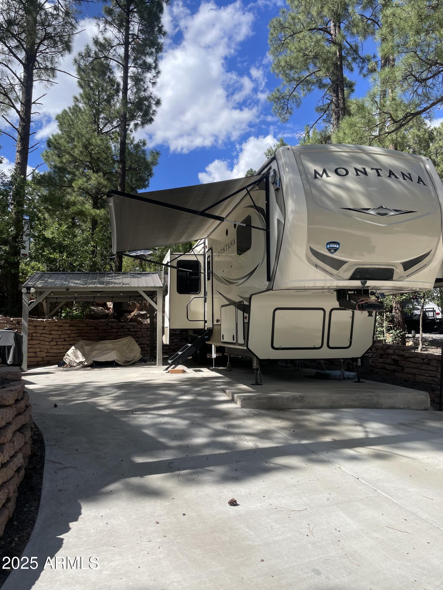 White Mountain Vacation Village is an amazing community. Vacant Land with cement slab, Ramada with electricity, lights, fan and shed. 5th Wheel also available for sale with separate bill of sale. Montana 3701LK 5th Wheel is 40 feet on cement slab, 2018 barely used, loaded with leather couches and chairs, king bed, 4 bump outs, washer/dryer/frig, sleeps 6-8. Club House activities can range from fitness, card games, board games, mahjongg, pool, bunko, bocce ball and corn hole along with a variety of community socials to better acquaint you with your neighbors. HOA covers water, sewer, trash, club house, laundry, Fiesta trail area.