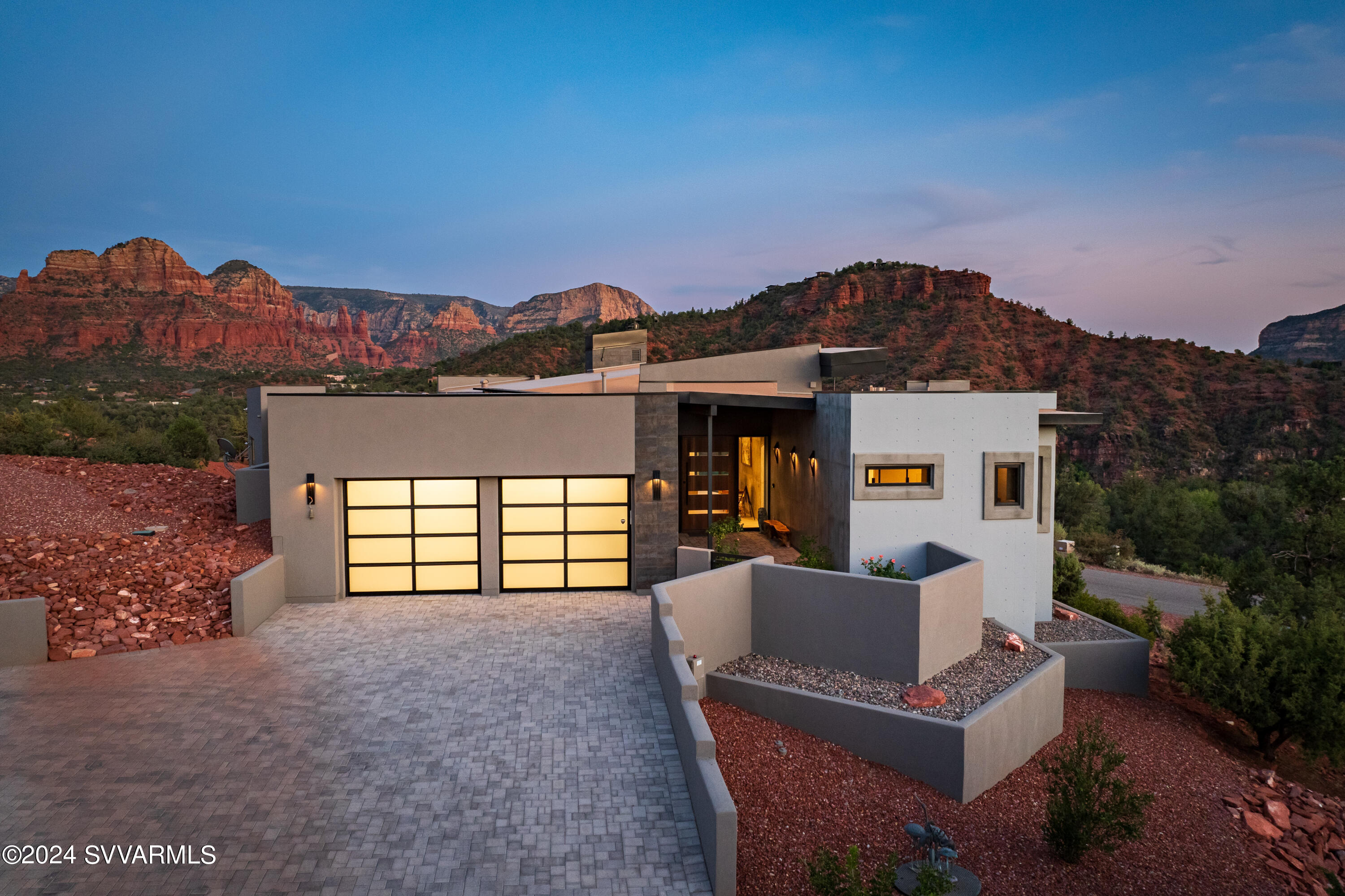 This spacious architectural gem offers everything you're looking for in a Sedona home; stunning natural views, minimalist modern styling, exceptional luxuries, and so much more, encompassed in a private oasis designed for ultimate relaxation and entertaining.

Entering through a massive wood front door, you'll be welcomed into a light-filled,
inviting living room with a tiled floor, and an dramatic vaulted wood ceiling edged on all sides by recessed lights. Highlights also include a large gas fireplace, contemporary linear
lighting, and floor-to-ceiling windows on two sides that frame some of Sedona's most
spectacular vistas, including Cathedral Rock, Chapel of the Holy Cross, and the Two
Nuns - yours to enjoy every day from the comfort of home. The living room is flanked by a gorgeous open kitchen outfitted to the cook's pleasure; including a Thermador glass cooktop, Thermador refrigerator, wine cooler, and an extra wide under-mounted Franke stainless steel sink. The large island is dressed in fresh white marble with a hint of gray, with room for six bar-height chairs - perfect for morning coffee or to serve guests.

Off the kitchen, you'll find a well-equipped Butler pantry with plenty of storage, a beautiful powder room for guests, and a large laundry room with washer & dryer.

The En suite primary bedroom, located off the main living space features expansive windows across two walls, with sliding door access to the roomy private paver patio equipped with a built-in gas grill, salt water hot tub, and built-in fire table.

A large walk-in closet offers abundant storage and hanging space. The expansive bathroom features double sinks across an extra wide counter, a zero entry, ¾ glass and tile shower with a bench, and a garden tub with a large window for even more stunning views of Sedona's natural beauty.

The two secondary bedrooms, located to the right of the main living area, are also En suite, and offer both privacy and comfort. Each one features, glass and tile shower with a bench, large vista windows, and exceptional views. All three bedrooms feature quality wood floors.

Builder plans available by request that include a potential ADU.