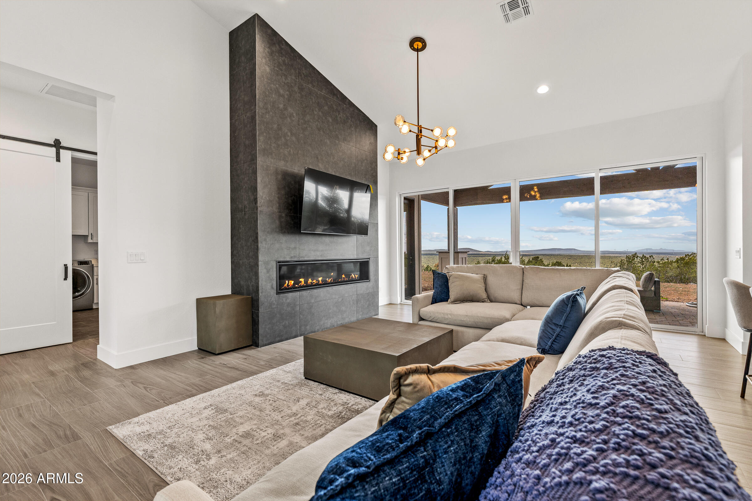 Experience rustic elegance in this brand-new ranch-style retreat set on 5.34 acres in Williams, AZ. This thoughtfully designed 4-bedroom, 2.5-bath home offers a spacious 2,251 sq. ft. split floorplan with an open concept living area featuring a dramatic waterfall island, custom tile backsplash, and walk-in pantry. The primary suite boasts a spa-like bath with double vanities, soaking tub, and walk-in closet. Enjoy breathtaking views from the extended covered patio or cozy up by the fireplace. An oversized 3-car garage provides ample storage, while dual-pane windows and modern finishes add comfort and efficiency. Located in the gated Red Lake Mountain Ranch community, minutes from downtown Williams and the Grand Canyon, this home blends seclusion, convenience, and luxury living.