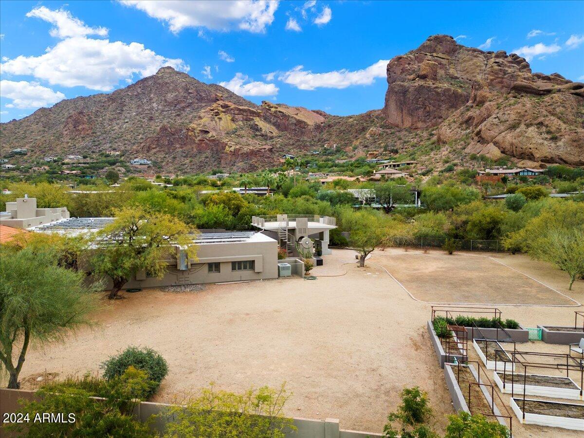 Rare opportunity to purchase a flat 1+ acre lot with stately views of Camelback Mountain, Mummy Mountain, and the Phoenix Mountain Preserve.  Conveniently located within minutes of the new Global Ambassador, world class resorts, shopping, dining and golf!  The home on the property is being sold in As-is condition at no value.  Property is being marketed and sold at land value.
