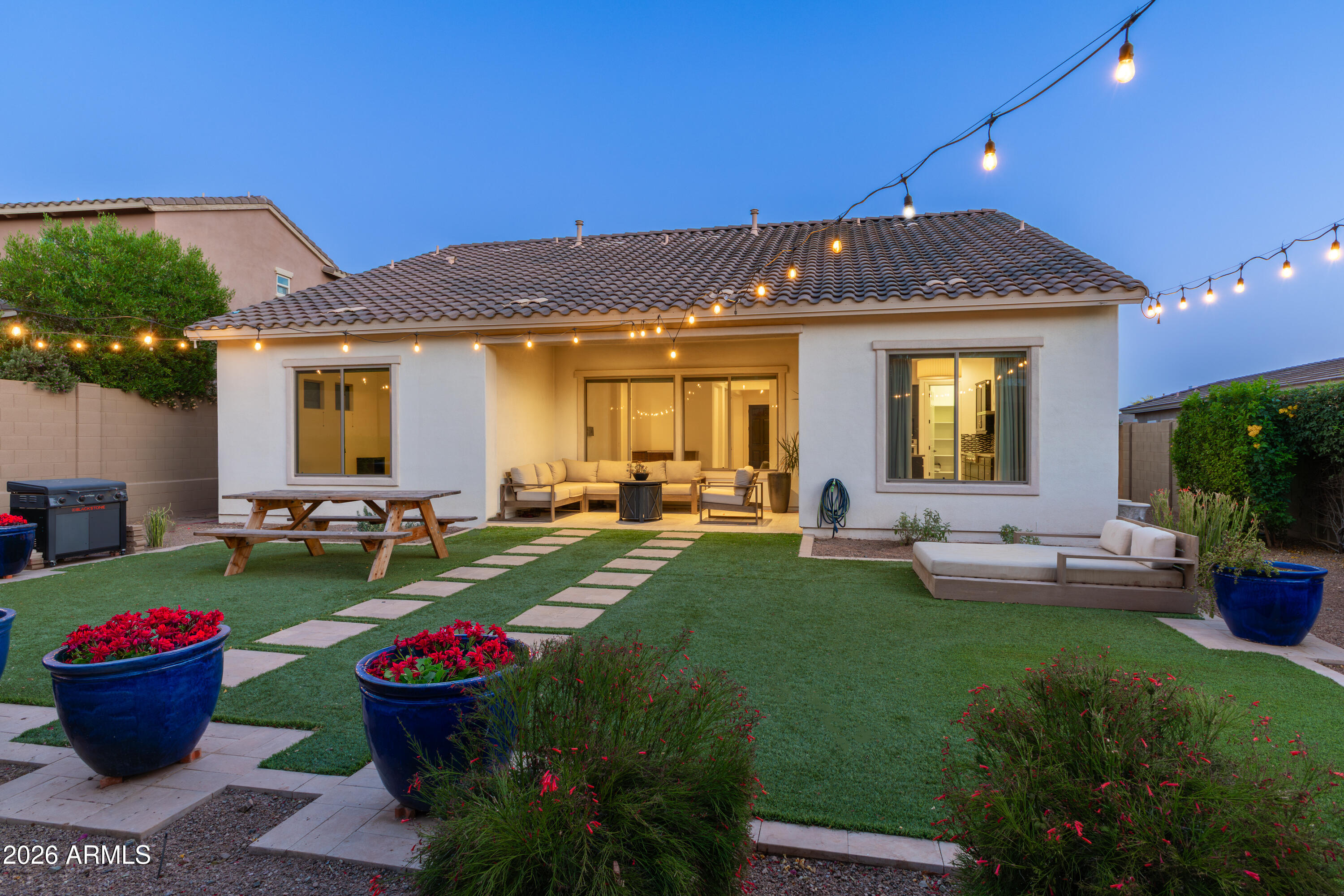 Located in the highly desirable gated community of Montevista, this beautiful home sits across from one of the lush green belts and near the community gate for added convenience. Surrounded by playgrounds and inviting outdoor spaces, this neighborhood offers both comfort and lifestyle. This spacious split floor plan by Toll Brothers offers everyday living and entertaining. Welcoming you with a charming jasmine courtyard and elegant iron gate entry, the home opens into a spacious foyer with a versatile formal living room or den nearby.
The heart of the home features an open-concept kitchen with pantry, breakfast nook, chef-style gas stove, & large living room overlooking the covered patio perfect for indoor and outdoor gatherings. Adjacent to the kitchen is a formal dining room featuring built-in cabinetry and a beverage fridge area, creating the perfect space for entertaining.
The thoughtfully designed layout places two secondary bedrooms on one side of the home, connected by a spacious teen/bonus room along with two bathrooms, creating an ideal setup for family or guests. The private primary suite is tucked away on the opposite side of the home and features a large primary bathroom, generous walk-in closet, and peaceful separation from the secondary bedrooms.
Step outside to the low-maintenance backyard with green artificial turf and covered patio, designed for relaxing Arizona afternoons. Additional highlights include a spacious laundry room with sink, oversized garage, multiple storage closets, recent exterior paint and new carpet in select bedrooms.
Conveniently located near fine dining, premier shopping, and beautiful desert trails and recreation, this home offers the perfect blend of comfort, convenience, and Arizona living in an exceptional location.