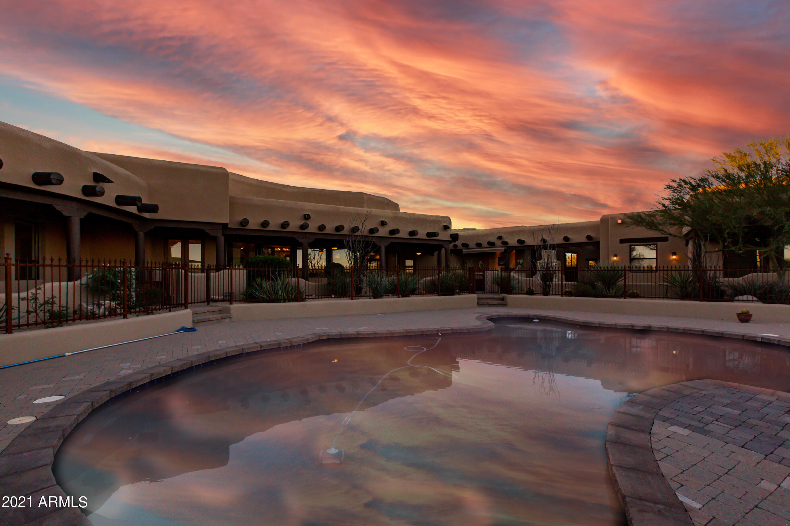 Casa Del Caballo meaning the ''house of the horse'' is a horse lovers and entertainers dream. This
lush estate is spread over 9+ acres and is situated in the beautiful desert landscape. This unique
southwest style home has warm wood lodge poll beams and hard wood flooring. Luxury features
abound including hand carved cabinetry, custom built-ins and art niches.The gorgeous circular entry opens to the massive great room with open style dining space, kiva fireplace, custom entertaining area and huge wall of windows that frame the backyard, pool and stunning Granite Mountain views beyond. The large gourmet kitchen is the heart of this home
and the perfect spot for entertaining. A custom island featuring hand carved cabinetry and granite countertops dominates the center of the kitchen. Create yummy meals with the double chef's stove plus double subzero fridges. The owners suite is it's own private oasis. Gorgeous views from the another wall of windows. A luxurious bath with soaker tub and large snail shell shower and double sinks. Plus two closets with custom shelving, coffee and wine bar, an attached office plus den/work out room finish off the owners suite. Cozy fireplaces are situated in each of the spacious 3 guest bedrooms for those cool desert nights. Each guest bedroom has its own bath. The separate Media room is the perfect spot for watching the big game or movie nights. Outdoor living space in this estate includes a spacious kitchen and barbecue area, secluded patios
and tropical pool. Sunbathe on the stone deck surround or float and enjoy the mountain views from the pool. Artificial turf grass area provides space for play or putting. Citrus grove provides an abundance of grapefruit, lemons, and oranges.
Attached 2 bedroom and 2 bath casita with kitchen gives plenty of space and comfort for your
guests.
The surrounding grounds provide top notch horse facilities. 2 barns include a 16 stall mare motel
with built-in hot and cold water wash pen, also an 8 stall show barn with attached 1 bedroom
living quarters. Custom gravel footing in both large show area and the dressage arena. In addition
to several corrals plus training facilities, there is a hot walker and round pen, wash rack and tack
barn. Ride from your home with access to trails and the foothills beyond.
Automatic gated entrances separate from the main entrance allow for access to horse facilities
and easy access for trailers. Out of the way designated trailer and equipment parking.
You will also find an attached 4 car garage providing plenty of space for cars and toys.
Casa Del Caballo is your luxury desert oasis with pristine horse facilities and home all on 9 acres of beautiful desert landscape.