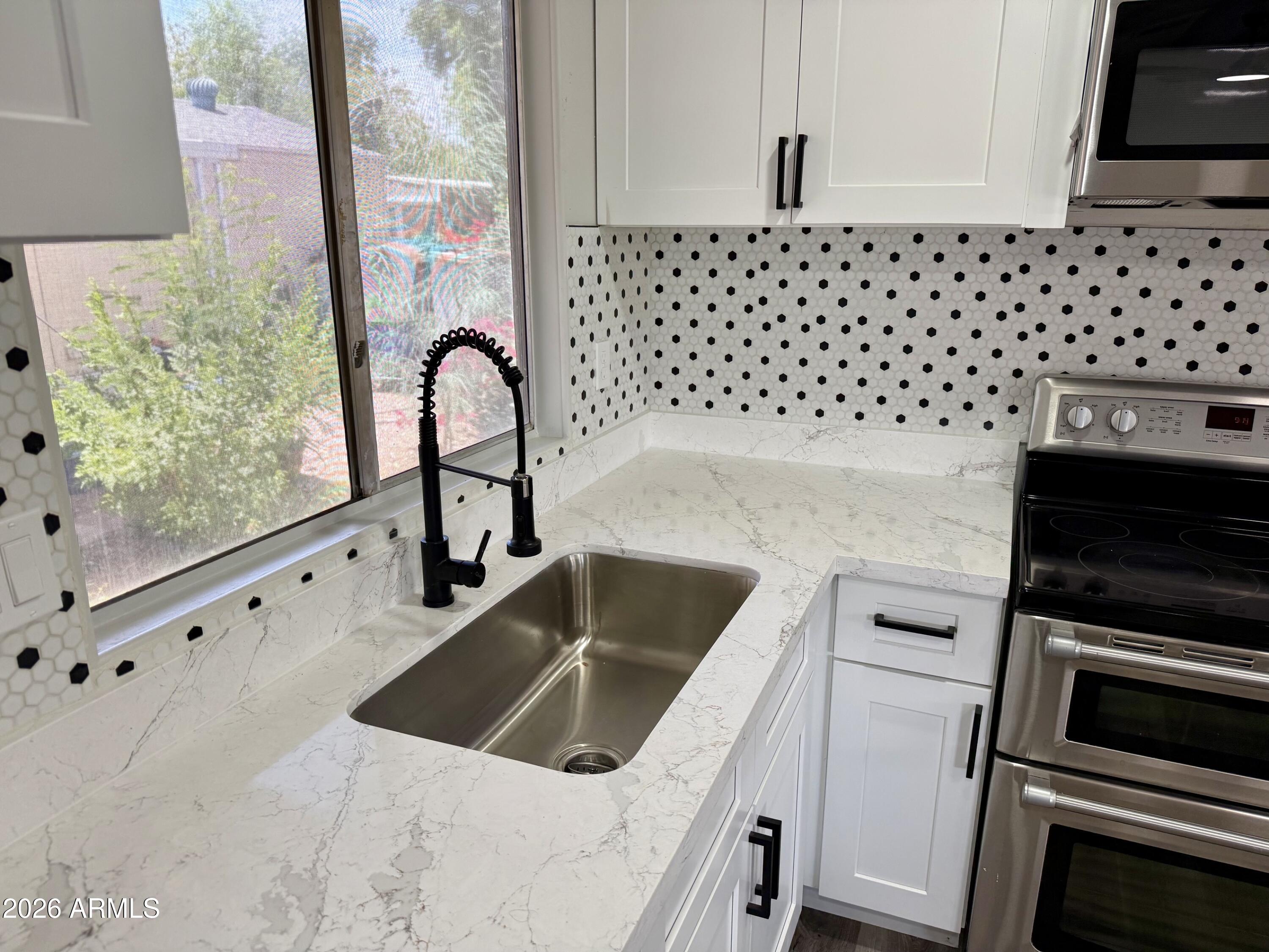 This lovely remodeled home in Paradise Groves MHC has fresh paint, newer appliances, new counters, floors and more.  This is an all ages community and park approval is required.