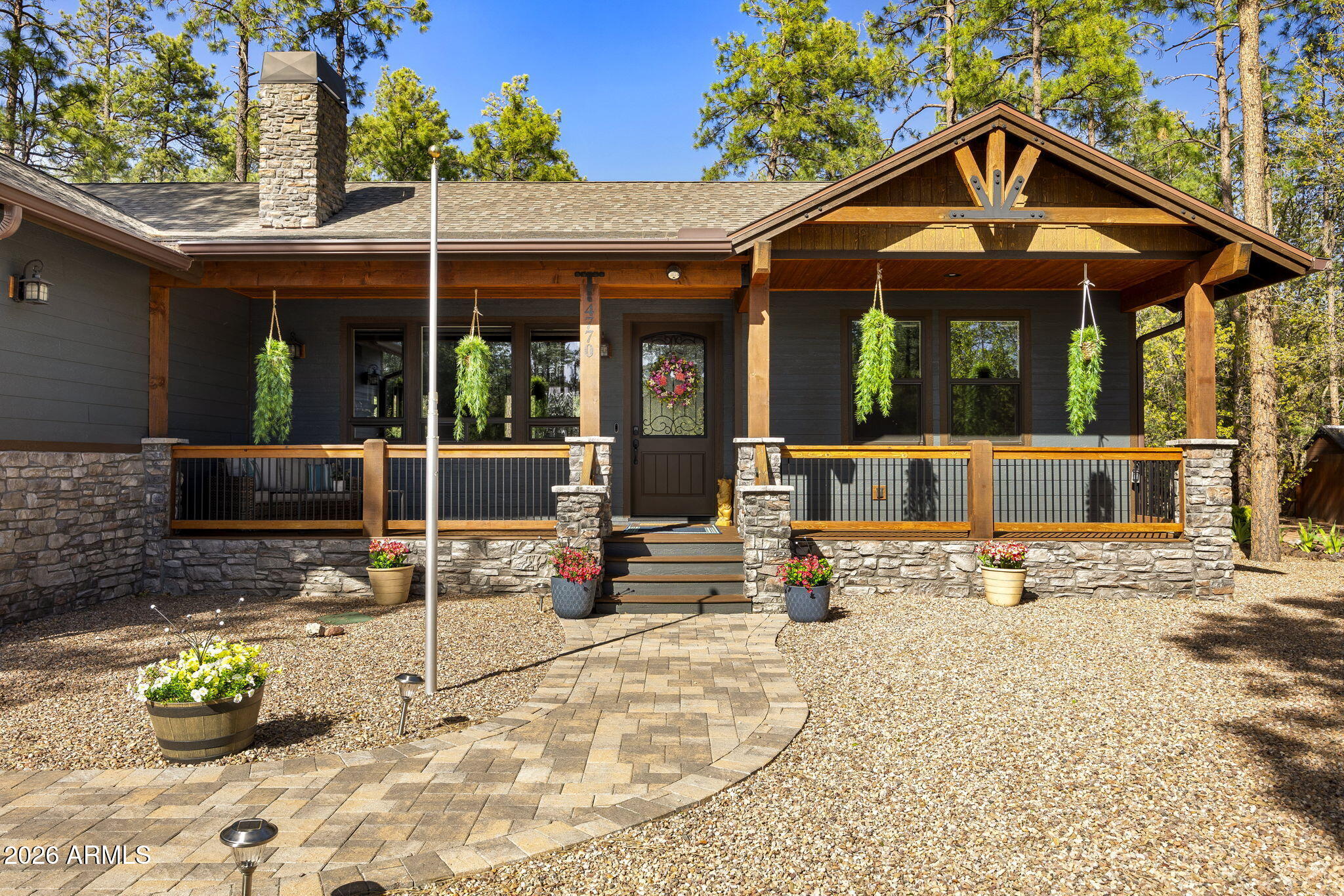 Enjoy mountain luxury living in this exceptional 3BR/3.5BA, 2,460 SF home in the gated Mountain Gate community, perfectly positioned to take advantage of the HOA-owned common area directly behind the property; ensuring no one can build behind you and providing an added sense of privacy and open space. Elegance, comfort, and true pride of ownership shine throughout. A paver driveway and covered front deck with low-maintenance Trex decking welcome you with warm wood and stone accents, setting the tone for the craftsmanship inside. Step into an open-concept great room featuring vaulted ceilings with beautiful custom beams, flowing plank flooring, and a stunning floor-to-ceiling rock gas fireplace; perfect for cozy evenings. Step inside to an impressive open-concept great room where soaring vaulted ceilings with striking custom beams create a warm yet grand atmosphere. Flowing plank flooring, abundant natural light, and a dramatic floor-to-ceiling rock gas fireplace come together to create the ideal gathering space for entertaining or cozy evenings at home.

The thoughtfully designed split floorplan offers privacy, with each oversized bedroom featuring its own ensuite bath, plus a convenient half bath for guests. The kitchen is designed for both everyday living and entertaining.

The kitchen offers a gas stove, spacious island, abundant cabinetry, and generous counter space. Just off the great room, a serving bar with wine fridge creates the ideal setup for hosting and gathering.

The oversized primary suite provides a relaxing retreat with a sitting area and private access to the back deck. The spa-like ensuite features a soaking tub by a window, glass-enclosed shower, dual granite vanity, and a large walk-in closet with custom storage.

Outdoor living truly shines with Trex decking on both the front and back covered decks, enhanced by beautiful T&G ceilings that add warmth and character. The expansive back deck features a striking floor-to-ceiling fireplace, perfect for getting cozy while enjoying the cool mountain air. Just beyond, beautiful pavers extend the entertaining space, and the partly fenced yard offers added functionality and privacy. One of the standout features of this property is the sliver of land directly behind the home, which is HOA-owned common area, meaning no one can build behind you; preserving the peaceful setting, open feel, and exceptional privacy.

Additional highlights include an epoxy-coated garage floor, spacious laundry room, and an exterior storage shed; perfect for storing outdoor furniture cushions and seasonal items.

Perfect for entertaining or comfortable family living, this home offers an ideal blend of luxury, functionality, and mountain lifestyle.

***

Discover the White Mountains of Arizona--where adventure, beauty, and fresh mountain air come together. Enjoy four stunning seasons, 40 lakes, and 600+ miles of rivers and streams, perfect for fishing, kayaking, and exploring.

Hit the trails on one of the largest trail systems in the Southwest, or spend winter days at Sunrise Ski Resort, just 40 minutes away with three mountains of skiing, snowboarding, and sledding.

Love shopping or culture; wander through antique shops, summer arts & craft fairs, and lively music festivals. Golfers can tee off at seven scenic courses, including three public gems.

It's no wonder Pinetop-Lakeside was voted the "Best Cabin Region in the U.S."

The White Mountains--Arizona's best-kept secret. Come explore and embrace the MAGIC!