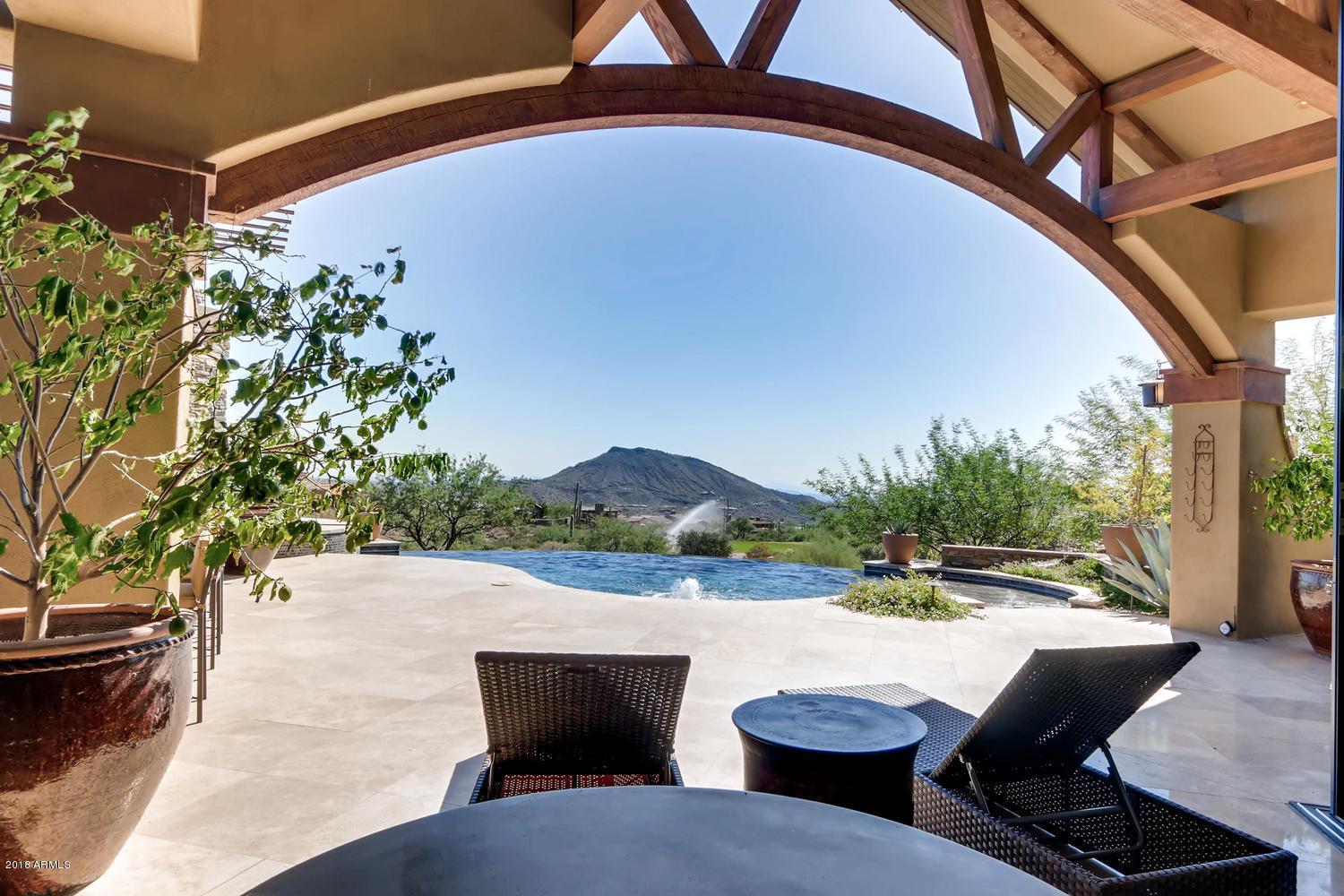 Priced to sell!!  This one of a kind rustic contemporary is an entertainers dream home.  Fabulous style, elegant casual comfort and spectacular views from every room. The free-flowing plan is designed for seamless indoor/outdoor living, incorporating small intimate spaces as well as larger gathering spaces. Retractable floor-to-ceiling glass walls were designed to keep desert and mountain views unobstructed and to join the great room to a 2786 sf covered patio with two fireplaces, outdoor kitchen and adjacent negative-edge pool. Phoenix Home & Garden showcase home April 2015! No membership to the desert Mountain is included in the sales price, but is available upon application to the Desert Mountain Club.