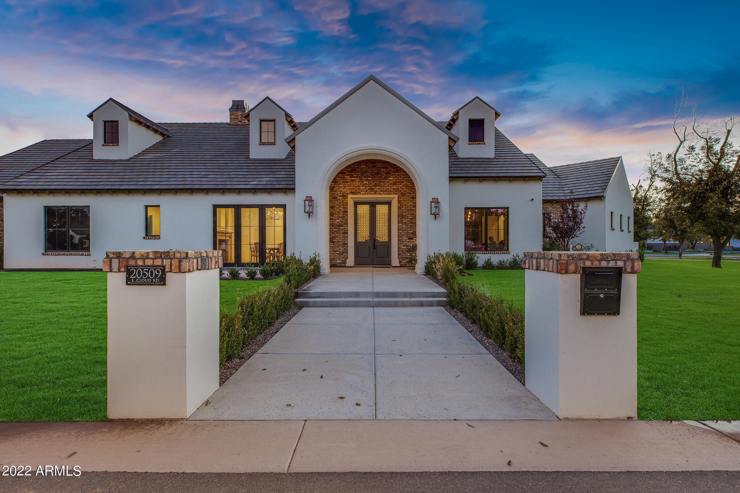 This custom home built by luxury home builder, Arizona Construction Plus, was completed in June of 2022 giving you the rare opportunity to live in the highly desired Pecan Lights without having to go through a long build process. The Country French inspired home sits on 1.32 acres and is 7,058 sq.ft livable with a 736 sq.ft detached guest house, a detached garage and pool cabana. The main house consists of 5 bedrooms, 4 full baths and 2 half baths while the guest house consists of 1 bedroom, 1 full bath, living room and full kitchen. 

As you walk through the custom entry doors with hand blown European glass you step inside the foyer with a custom marble floor and custom coffered ceiling. The formal dining room showcases a custom limestone fireplace, French oak hardwood flooring in a herringbone pattern and a reclaimed beam with an active dormer at the ceiling. As you make your way through the 6' wide gallery into the kitchen and family room you immediately notice that no expense was spared in the design. With features that include Water Stone plumbing fixtures, Wolf Sub Zero appliances and a one of a kind 12' tall zinc exhaust hood. The white oak island has book matched Bardiglio marble slabs. The great room boasts 22' vaulted ceilings with exposed trusses over tongue and groove planks. On the way to the east wing there is a game room with custom coffered ceiling and home movie theater with custom starlight ceiling and Dolby atmos surround sound. You'll find a mud room with custom plaid marble flooring and built  in lockers. 3 bedrooms with custom cove ceilings and their own bathrooms are located near the kid's den and separate kid's laundry room. The west wing includes a spacious primary suite with custom bathroom including fixtures by Crosswater of London, marble slab walls, white oak vanities and custom walk in closet. The 5th bedroom could be used as a home gym or nursery due to its close proximity to the primary suite.  

The home is equipped with a full Crestron lighting control system, custom sound system and security system with 13 cameras covering the entire property. The outdoor space has bluestone pavers, a large pool and spa, outdoor kitchen, outdoor fireplace, outdoor pizza oven, mature pecan trees and an assortment of professionally designed landscaping. Living at The Pecans affords a completely different experience from typical Arizona communities. Come home to canopied boulevards with wide, tree-lined medians fronted by custom homes. The community is alive with parks, playgrounds, splash pad, a putting green, and miles of walking and biking trails. And everywhere there's the splendor of the trees with their cooling shade, lush foliage and ever-changing colors. The Pecans is referred to as an Arizona surprise because a feeling of unexpected wonder is the reaction from everyone who is introduced to this extraordinary property. For the past 30 years The Pecans has been a working grove with thousands of mature pecan trees. In this enchanting environment, is a custom estate community with just 258 Queen Creek Home sites.

See attached document for additional upgrades.