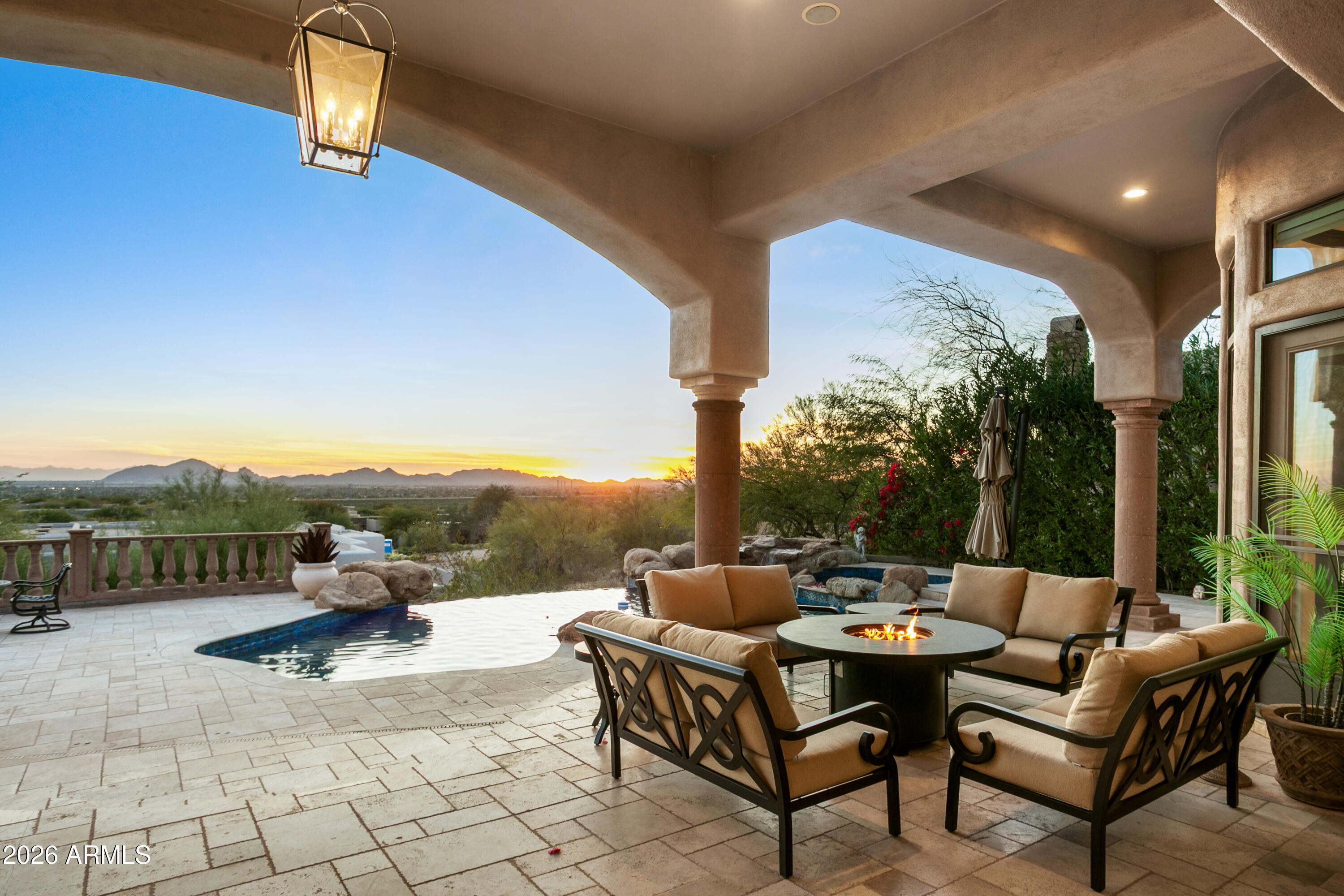 This property is truly a must-see in person, as photos cannot fully capture the spectacular hillside views from this lot in Ancala Country Club. This home features 5 bedrooms plus a library/den and 7 bathrooms, with soaring 18-foot ceilings and unobstructed views of Arizona's iconic sunsets from nearly every room.  The open floor plan includes a full sit-down bar, a casita, and a walk-out basement. The outdoor space is perfect for entertaining, featuring an expansive covered patio with a built-in fireplace, a BBQ, and an infinity-edge pool and spa with all-new equipment.
Significant renovations were completed in 2023 for the great room, bar, kitchen, and primary suite. The basement was also recently updated to include two bedrooms, two bathrooms, a living area, a kitchenette, a private... patio, and direct access to the pool.

Located in a 24/7 guard-gated community, the home is close to golf, schools, trails, and fitness facilities. Please note that seller financing and furnishings are also available.