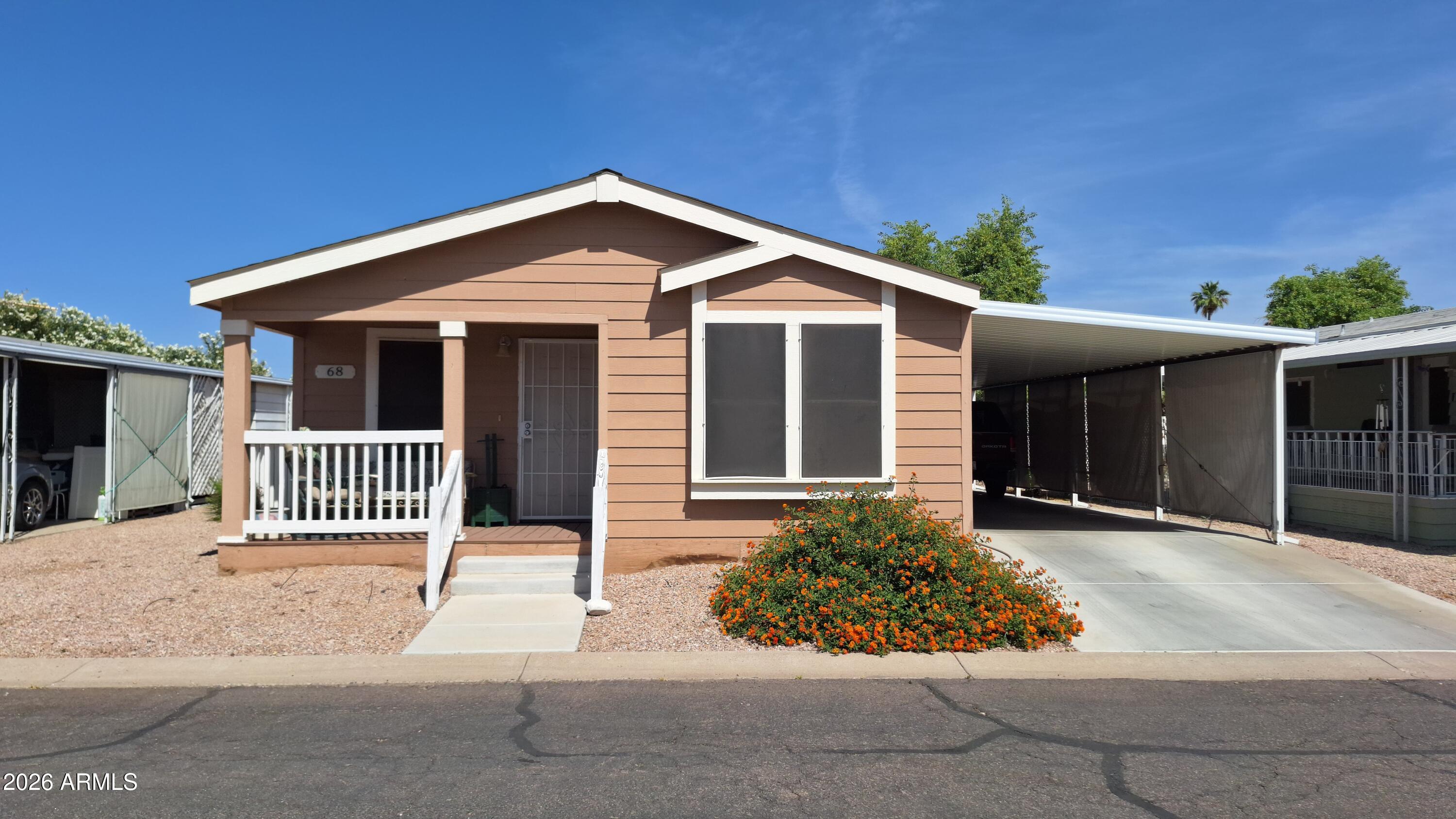 Located in the desirable gated community of Casa Del Sol Resort, this well-maintained home offers inviting curb appeal with a cozy front porch.  Inside, you'll find vaulted ceilings, a functional layout, and a mix of plush carpet and wood-look LVP flooring that adds both comfort and style. The kitchen is thoughtfully designed with rich wood cabinetry, a breakfast bar, pantry, and a dedicated dining space--perfect for everyday living. This home features 2 bedrooms plus a flexible den. Enjoy resort-style amenities including a community pool, spa, and clubhouse, all within a beautifully maintained setting.