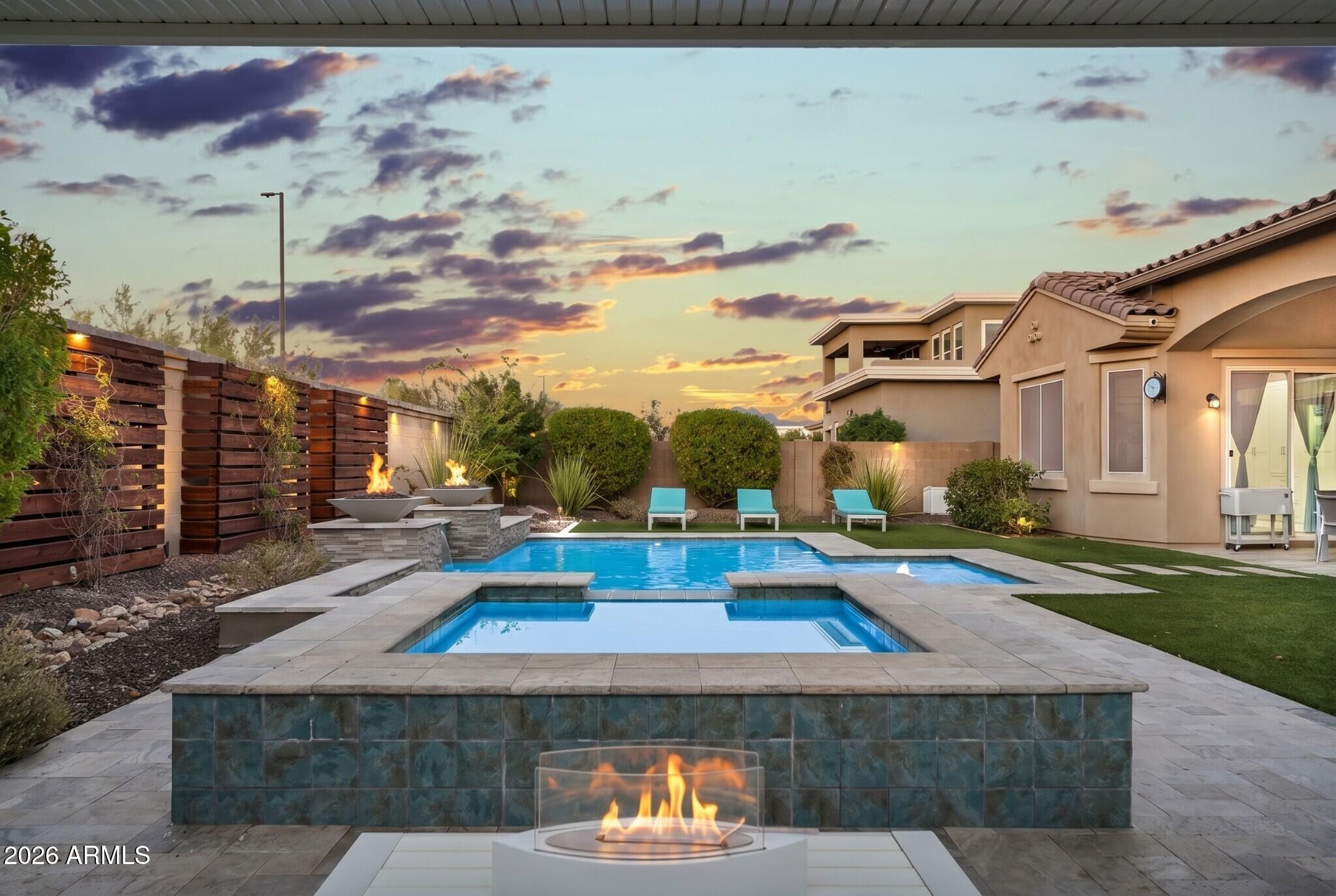 Nestled within the exclusive gated enclave of Granite Ridge, a private community of just 56 residences, this exceptional single-level home offers luxury, privacy, and breathtaking mountain views. Situated on a premium corner homesite with a desirable north-facing backyard, the 3,534-square-foot residence seamlessly blends elegant design with everyday comfort.

Designed for both entertaining and effortless living, the thoughtfully crafted floor plan features 4 spacious bedrooms, 4 full bathrooms, and a powder room, including a private detached casita complete with its own bedroom,  full bath, and kitchenette--ideal for guests, multigenerational living, a private office, or a fitness studio.

A gated rotunda-style courtyard creates a memorable first impression. Framing the entrance to the home, the courtyard also provides access to the detached casita. 

Just beyond the foyer, the formal living room offers a warm and inviting first impression. Bathed in natural light, it is flanked by expansive sliding glass doors that open to a private courtyard centered around a cozy outdoor fireplace. A second set of sliding glass doors connects the courtyard to the great room, creating a unique architectural feature that blends the lines between indoor and outdoor living while filling both spaces with light.  The great room welcomes family and friends with a custom built-in media wall while the while oversized wood beams overhead create a dramatic architectural statement and add warmth to the space.

Designed as the heart of the home, the kitchen seamlessly connects to the great room and spacious dining area, where there's ample room for an oversized dining table.  Equipped for both everyday living and entertaining, the kitchen showcases extensive cabinetry, granite countertops, an oversized island that naturally becomes the gathering place, a gas cooktop, pendant lighting, a well-appointed butler's pantry with a beverage refrigerator, and a generous walk-in pantry.  The kitchen flows effortlessly into an inviting formal dining room, creating a warm and welcoming setting for everything from intimate dinners to holiday celebrations.

Tucked away in its own private wing, the primary suite offers a peaceful retreat with serene mountain views and private access to the backyard. A full wall of custom closet organizers provides exceptional storage, while the spa-inspired ensuite is thoughtfully appointed with separate dual vanities, an oversized soaking tub, and a spacious walk-in shower.

The true showpiece, however, is the extraordinary walk-in closet. Custom designed by Classy Closets and honored with the 2024 Design Award, this breathtaking space--aptly named "The Glam Sanctuary"--is nothing short of spectacular. Designer wallpaper, dazzling statement lighting, elegant gold hardware, and boutique-style glass display cabinetry create a one-of-a-kind dressing room worthy of a luxury residence. Thoughtfully designed to showcase an impressive wardrobe, handbags, and shoe collection, this remarkable space blends beauty, organization, and everyday functionality into an unforgettable experience.

Designed with privacy in mind, the two secondary bedrooms are situated on the opposite wing of the home, each occupying its own separate space. Both feature private ensuite bathrooms, providing  comfort and convenience for family members or overnight guests.

The backyard is a true extension of the home's exceptional living spaces. Expansive sliding glass doors spanning the length of the great room create a seamless transition to this private outdoor retreat. Designed for both relaxation and entertaining, the backyard showcases a custom Presidential Pools pool and spa, completed in 2020, accented by elegant fire pots and surrounded by travertine decking. A custom pergola, lush artificial turf, and thoughtfully crafted wood trellises with integrated lighting add warmth and character, while generous spaces for lounging, sunbathing, and gathering with family and friends complete this resort-inspired setting. Framed by picturesque mountain views and a desirable north-facing orientation, this outdoor oasis offers the perfect backdrop for enjoying Arizona's year-round lifestyle.

Rounding out the home is an oversized 3.5-car garage with professionally finished epoxy flooring, offering flexibility for multiple vehicles, storage, or hobbies. From its award-winning designer spaces and thoughtfully designed floor plan to its resort-style backyard and breathtaking mountain views, this remarkable Granite Ridge residence offers an unparalleled lifestyle in one of the area's most coveted gated enclaves.  

A beautiful place for life's next chapter -- 9838 E June Street