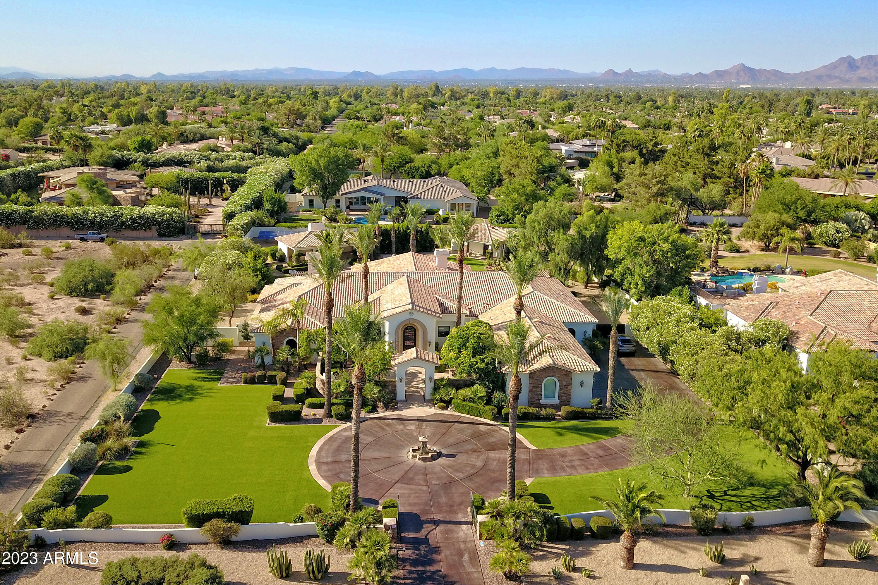 Welcome to Paradise Valley where luxury living reaches new heights. This exceptional estate offers a remarkable blend of elegance, comfort & modern amenities. Boasting a main house with 5,937 square feet of meticulously designed living space, including 4 bedrooms. 4.5 baths and 2 offices, along with a 704 square feet guest house, this property truly embodies the epitome of refined living. Step inside the main house and be greeted by a grand entrance that sets the tone for the entire residence. The spacious floor plan encompasses large open spaces. The master suite is a true sanctuary, featuring a huge master closet and a luxurious bathroom. Indulge in heated floors, double vanities, steam shower, towel warmer and the ultimate in convenience with 2 water closets equipped with Toto toilets. No expense was spared in the remodel and improvements of this estate, with over $1,300,000 invested to enhance its beauty and functionality. The gourmet kitchen cannot be beat, with gorgeous granite countertops, huge island, double wall ovens, a warming drawer and pot filler.  The newer roofs provides peace of mind, while the Venetian plaster walls and newer wood floors exude timeless sophistication. The newer HVAC systems ensure optimal comfort throughout the year, and the ground-mounted solar panels significantly reduce electric bills, making this home as energy-efficient as it is luxurious. Plus you can feel safe with fire sprinklers throughout the home.  Entertaining is a breeze with the abundance of amenities this estate has to offer. The huge covered patio, with its own misting system, invites you to relax and enjoy the breathtaking views of the surrounding landscape. Take a dip in the sparkling pool or unwind in the jacuzzi after a long day. The barbecues area is perfect for hosting outdoor gatherings, while the putting green allows you to practice your golf skills at your leisure. For a moment of tranquility, retreat to the gazebo and revel in the serenity of your private oasis.  Inside and out, every detail has been carefully considered. The property features synthetic grass throughout, providing a lush and low-maintenance landscape all year round. With speakers in every room and patio, you can enjoy your favorite music wherever you go, creating the perfect ambiance for any occasion.
Car enthusiasts will appreciate the temperature controlled four-car garage, complete with an electric vehicle charging outlet, ensuring your vehicles are well taken care of. The newer exterior paint adds to the striking curb appeal, leaving a lasting impression on all who visit.
Don't miss this rare opportunity to own an extraordinary estate in Paradise Valley. Immerse yourself in luxury, comfort, and unmatched beauty in this remarkable home that combines impeccable craftsmanship with modern amenities.