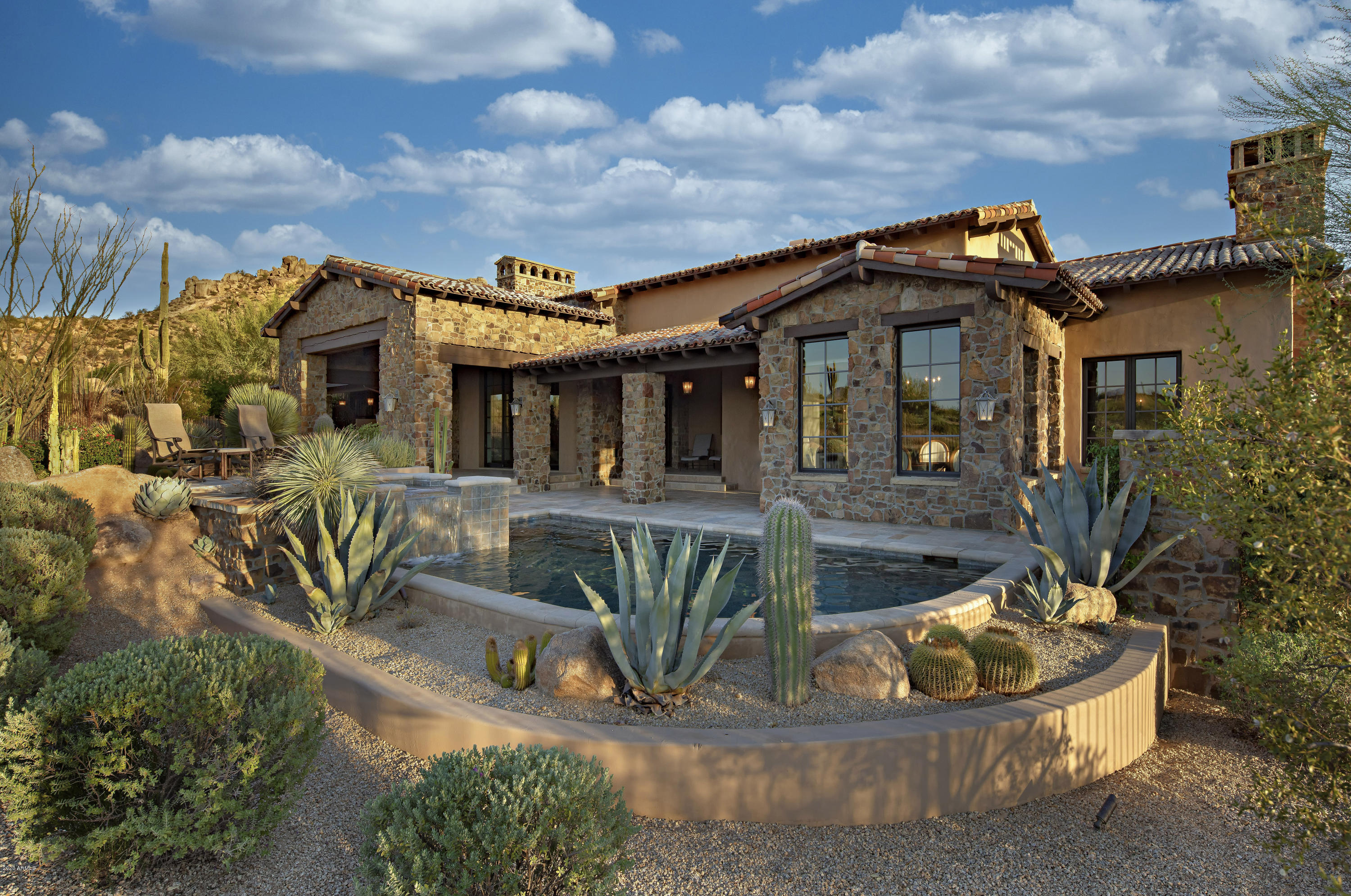 Exceptional craftsmanship and a keen attention to detail are displayed in this highly upgraded custom home on the 3rd hole in Estancia * Extensive use of hand-hewn woods & stacked stone accentuate the rustic, yet elegant details * Surfaces include stone & reclaimed wood flooring, granite counters & alder cabinetry * Split floor plan with master suite & office on a separate wing from guest bedrooms * Separate entrance guest house * Multiple pocketing doors create flow for indoor/outdoor entertaining * Chef's kitchen & classic wine room complete this unmatched property!