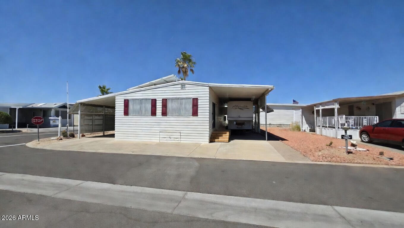 Opportunity awaits! Corner Lot 1255 is a plus sized parcel home to a ''Site Built'' Arizona Casita Home with covered RV Port. It's primed to be customized to the new owner's desires. Ready to go is the 6.7KW owned solar system, an additional covered carport for an extra vehicle or golf cart, work shop and storage room, Large sun room, tiled walk-in shower, washer and dryer, oversized bedroom, bathroom, and an amazing open area with kitchen, dining and living room all in one. Complete HVAC system updated in 2013. Covered RV port can accommodate most all RVs. With only floors and paint to go, this desert oasis is potentially the best value in the resort. Priced to move fast. The affordable HOA fee covers water, sewer, trash service and access to all amenities. Happy Trails Resort is a very lively 55+ Gated Community highlighted by Pickleball & Tennis Courts, Multiple Pools and Spas, Fitness Center, a Host of Craft Clubs, and Restaurant. Lots of Live Entertainment and tons of get-togethers mean there's never a dull moment. Come see what the Happy Trails Lifestyle is all about!