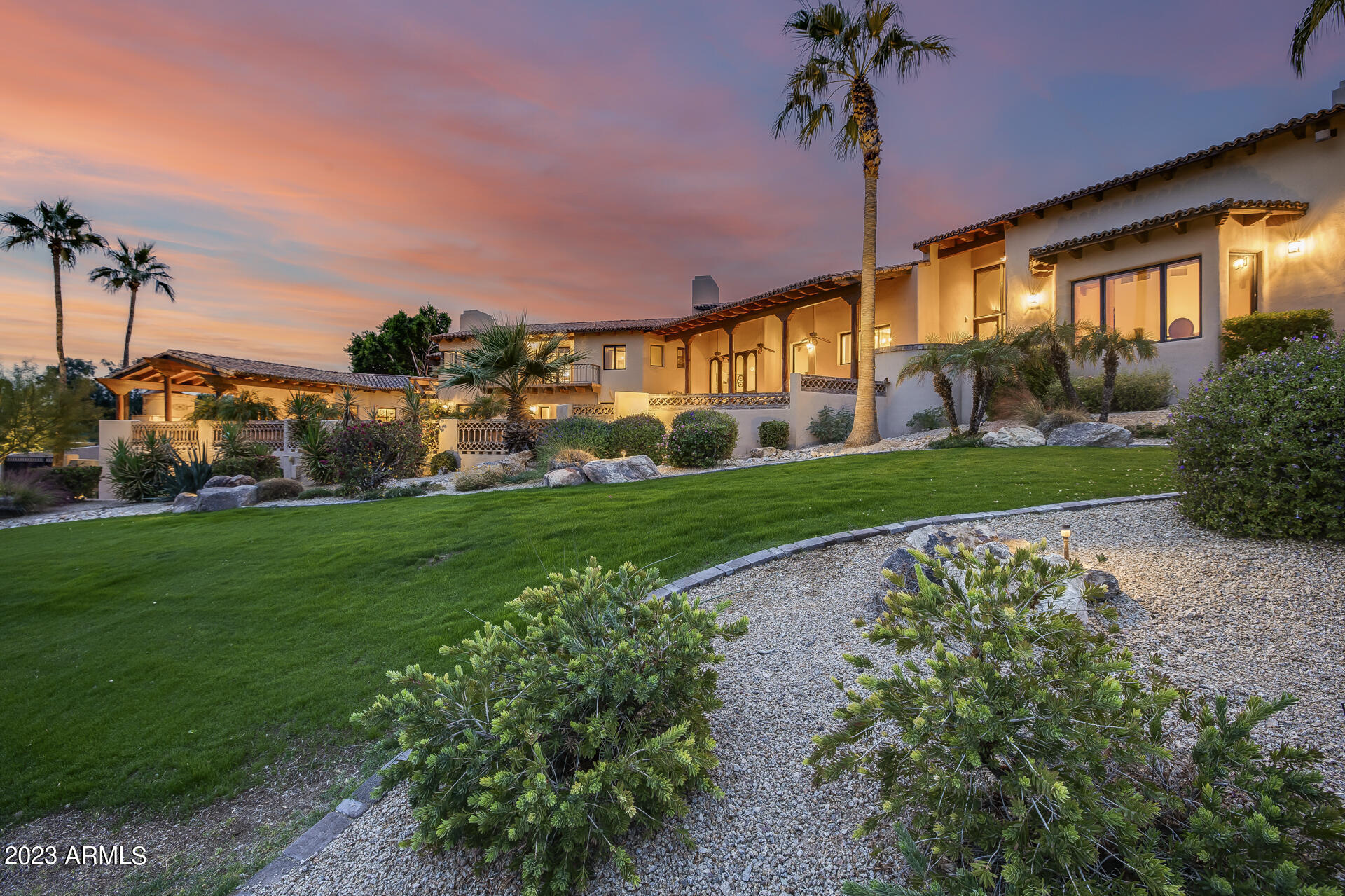 Timeless hillside estate with breathtaking views of Camelback Mountain! Designed by renowned architect, George Christensen, this incredible Spanish Revival villa exhibits soaring ceilings with exposed wood, arched windows, and top-of-the-line electronic sunshades & screens, wrought iron details throughout, & a gourmet kitchen with quartz & granite countertops, a large island, & high-quality Viking appliances including, an oversized side by side refrigerator, electric cooktop, & stainless steel wall ovens. With 5 beds, 4.5 baths, gym/sauna, den/office, separate casita with kitchen, & a large sport/tennis court overlooking a private wash, this expansive home offers endless opportunities for hosting or recreational activities. Primary suite featuring multiple private outdoor spaces with attached office. Meticulously crafted fountains, fireplaces, courtyards, & balconies that offer breathtaking panoramic views of Camelback Mountain, Mummy Mountain, & Piestewa Peak. This property showcases a distinctive shape that gracefully envelops the sparkling saltwater pool & spa, relaxing ramada with fireplace, top-tier outdoor built-in BBQ, & lush landscaping with a variety of fruit trees. Also featured, a 3-car garage, 2 electric car charging stations, & state-of-the-art wifi/app operated Smart Home capabilities including alarm, AC, Pentair Pool app, & whole home sound system. Nestled in the gated Paradise Valley community of Clearview with affordable monthly HOA dues and access to hiking/biking excursions, Mountain Shadows Resort, world-class golfing, shopping at The Biltmore, Fashion Square Mall, & local dining favorites like the famous El Churro restaurant, Steak44, Buck & Rider, Maple & Ash, & SIP Coffee Bar!