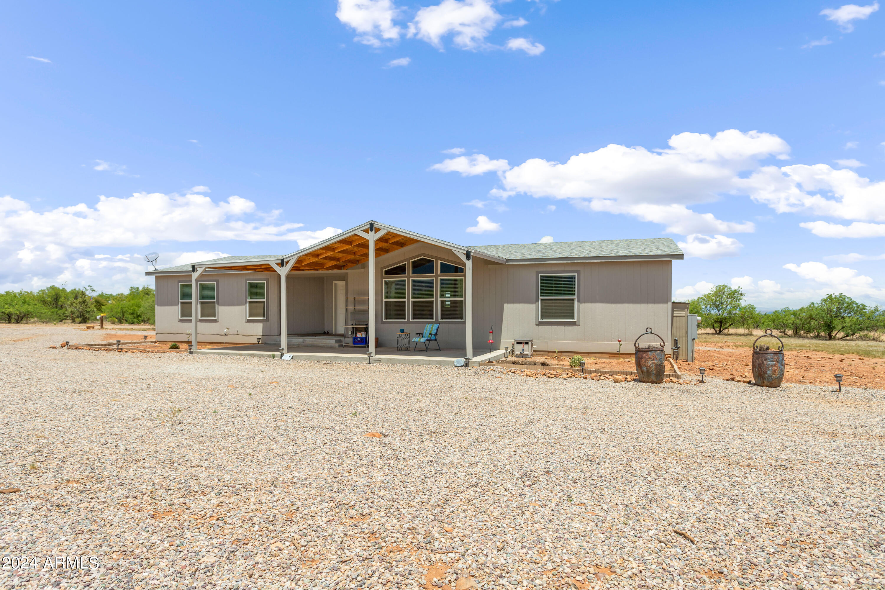 Newer manufactured home (2020) sitting on just over 1 acre corner of San Pedro Drive and Glisch. Spacious living area, dining and kitchen for all your entertaining and enjoyment. The kitchen has an abundance of cabinets and counter space, island and walk-in pantry. Home is a split floor plan with master bedroom on the opposite side of the house from the other 2 bedrooms. In the large master bedroom is a great ensuite and huge walk-in closet with a windrow and built ins. Outside a covered patio has been added to allow for amazing views of our mountains. Storage shed on the property will convey with the property. New roof on the home has a warranty that will transfer to the new owners. This house has to be seen to appreciate.