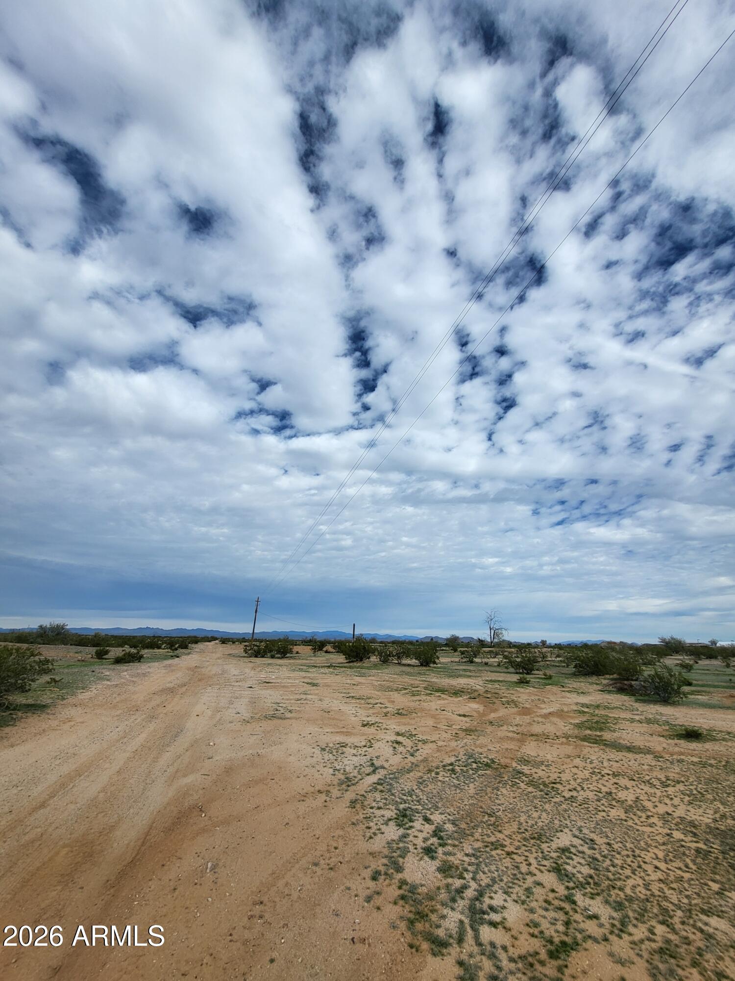 Blue sky and mountain views! In the great city of Surprise. Incredible opportunity to own 5 acres in the city of Surprise. There is a well on this parcel and road access from Pinnacle Peak. You can build or subdivide.The lot is square and flat. Easy access to the land.