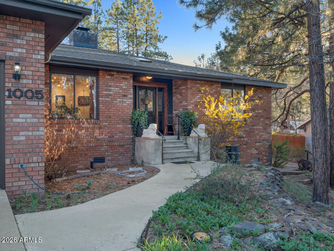 This dream home is surrounded by stately pines and oaks, several native and perennial gardens including water features, backyard studio and more. Located on the southern edge of Williams, AZ. This 2128 sq. ft., single level, 3-bedroom, 2.5-bathroom house has an oversized two-car garage / workshop. It is within the city limits, with all utilities and services, but feels like you are living in the country. It borders undeveloped forest land with an access gate that connects to many beautiful hikes including Bill Williams Mountain and Clover Springs Trails. Nearby recreational opportunities include fishing at Buckskinner Park, and Santa Fe Dam, with the city pickle ball and tennis court only blocks away. ALSO SEEN on NAAR MLS # 203892
