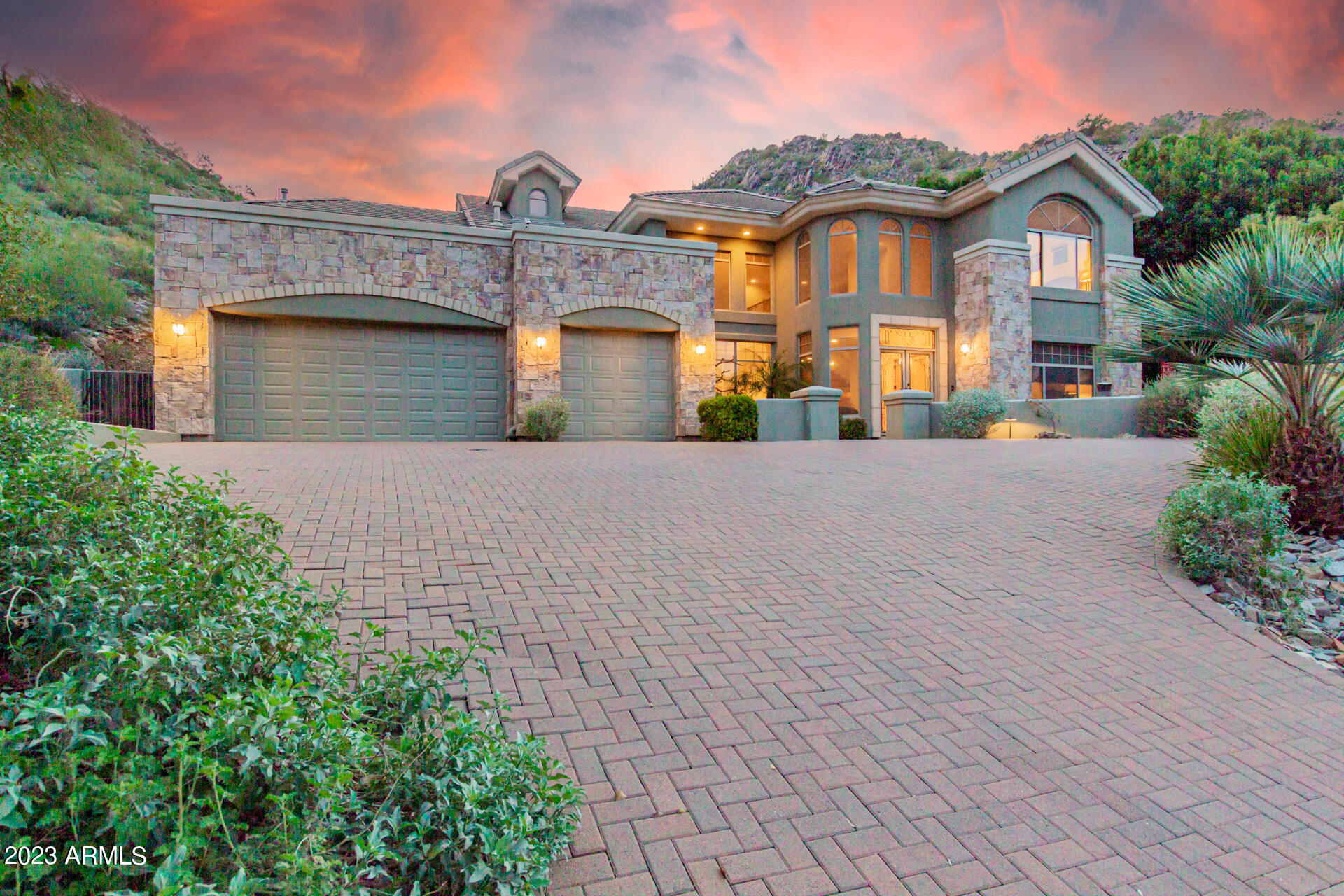 Rare hillside home with a full backyard and pool!! If you want a peaceful retreat, this luxurious two-story home backed up to the Phoenix Mountain Preserve has your needs covered! Situated on a quaint cul-de-sac lot with breathtaking mountain and city views! Excellent curb appeal with professionally manicured landscape, stone accents, a courtyard with water feature, pavers, & a 3-car garage w/an extended driveway. Be welcomed by the lovely foyer w/a charming chandelier upon entry and an adjacent office/den/bedroom. Stunning interior boasts soaring ceilings, recessed lighting, picture-perfect windows, stylish tile flooring, archways, wall accents, a formal dining room w/so much natural light, & a living room w/a cozy fireplace & entertainment niche. Ask to speak to listing agent. Impeccable gourmet kitchen is fully equipped w/SS appliances, plenty of honey oak wood cabinets, granite counters, a pantry, a breakfast area, & two islands, one w/a 2-tiered breakfast bar. Upstairs, you'll discover a bright loft, small office/storage room, & a bonus room w/a skylight & balcony access, great for entertaining. The large owner's suite is located on the main level, showcasing a soft carpet, patio access, & an immaculate ensuite w/two vanities, a jacuzzi tub and walk-in closet. Another three carpeted bedrooms upstairs enjoy incredible views outside, and private bathrooms. Beautiful backyard is a paradise! A covered patio, pavers, lush lawn, trees, an outdoor built-in BBQ, a hot tub, & a sparkling pool complete the picture. Words don't do it justice. Make this gem yours now!
