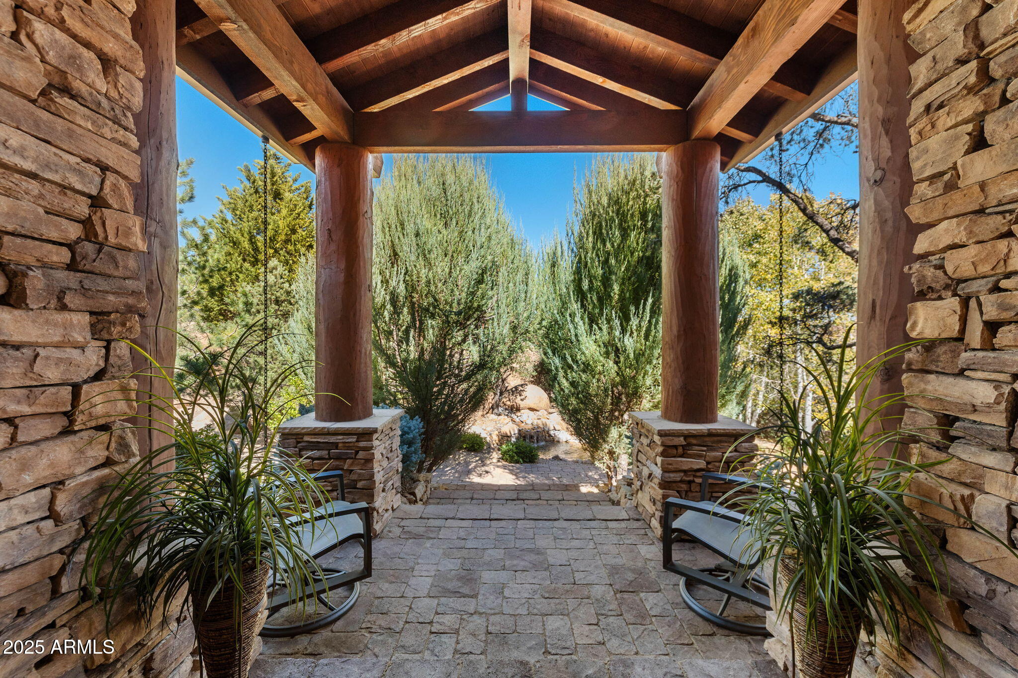 Experience elevated living in this custom 5690 sq ft estate nestled on 3.13 acres. Designed for both luxury and livability, this home offers panoramic views of Granite Mountain through dramatic walls of windows in the living room and master suite. The main level features a spacious master retreat and a private mini-master, complemented by a dedicated TV/Den room , formal dining and breakfast room. The gourmet kitchen boasts high-end appliances, striking blue quartz countertops and backsplash, & custom cabinetry with abundant storage.  Downstairs you will find an additional bedroom, office and space to entertain effortlessly in the expansive game room with a full-size bar or the large media room for movie nights at home.
Outside, enjoy the wrap around deck, waterfall, fireplaces & spa! More...
The outdoor space offers wraparound decks and multiple patios including an elevated hot tub with built-in gas fireplace to create seamless indoor-outdoor living. A show-stopping 70+ foot waterfall feature adds tranquility and visual drama to the landscape.
Additional highlights include a 3-car garage with luxury epoxy flooring, unique architectural details, and access to American Ranch amenities: full equestrian facilities, clubhouse, pool, fitness center, and more.
This is a rare opportunity to own a one-of-a-kind mountain-view masterpiece in one of Prescott's most sought-after communities.