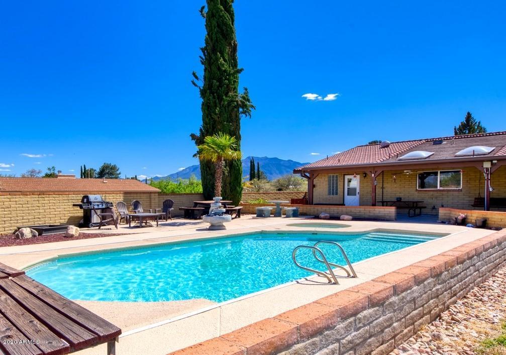 HUGE PRICE REDUCTION! Enjoy the Privacy of this Beautiful 5Bd/3Ba home on .67 fenced acres. The Spacious & Open Living Room/Family Rooms have vaulted ceilings that lead out to the back covered patio where you can entertain in the over-sized backyard or have a COOL dip in the POOL! The gourmet kitchen boasts Corian counter tops, cherry wood cabinets, & island breakfast bar & nook. The additional room - with a separate entrance - can be used as an additional master, guest room or?? Another set of doors lead out to the extended patio from the master suite that includes a large roomy bathroom w/double sinks. NEWER appliances, kitchen tile, paint, low-flow toilets, hot water heater & pool cover. There are THREE Bathrooms with one adjacent to pool area! This home has it all!