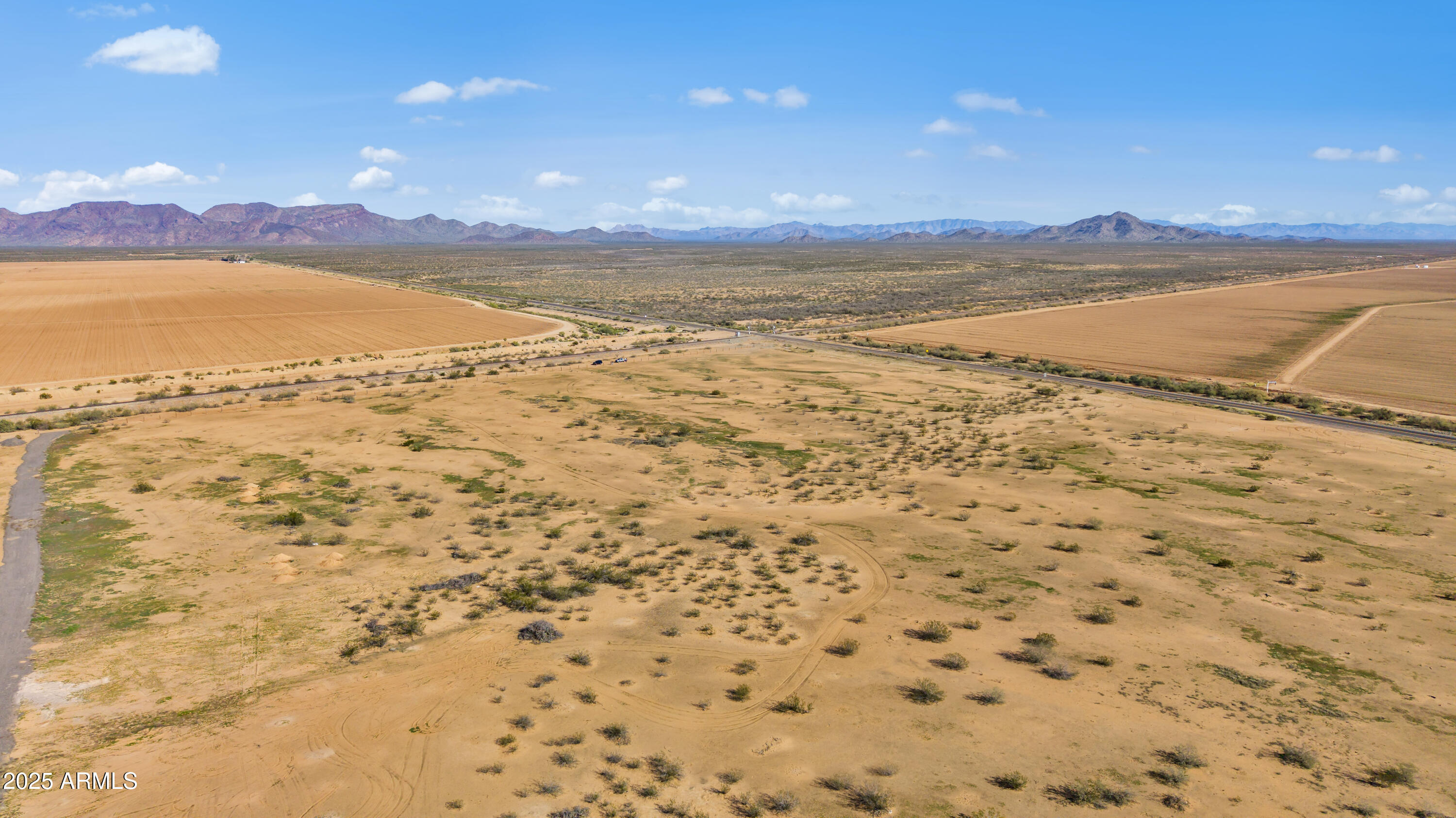 Your opportunity to own 5.25 acres of flat, usable desert acreage with unobstructed mountain views in the peaceful town of Aguila, Arizona! This expansive parcel offers the freedom and privacy rural buyers are searching for, whether you're planning a custom home, horse property, or a private desert retreat. Zoned R-43, this land provides flexibility for residential use with plenty of space for outbuildings, RV parking, livestock, or your dream homestead. No utilities currently on the lot, but electric and phone lines are located within approximately 350 feet, making future development more accessible and cost-effective. Enjoy the serenity of wide-open spaces while still being close to nearby stores and conveniences. Investors will appreciate the growth potential in this West Valley.