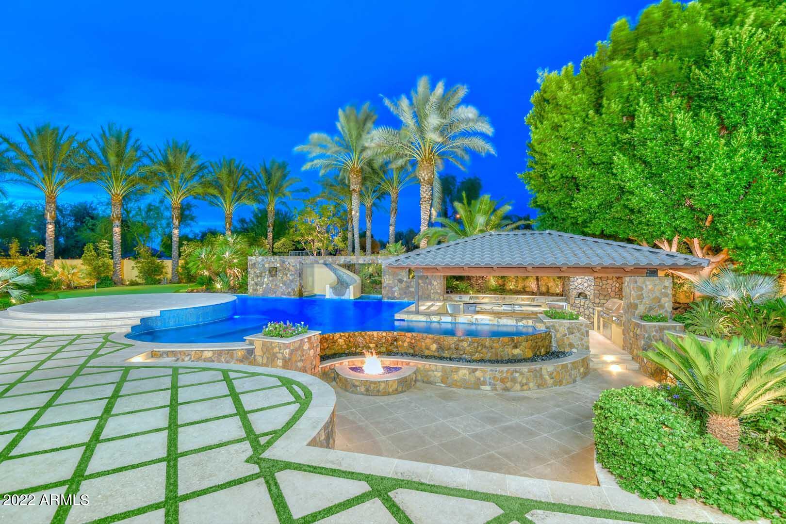 Set in the prestigious gated community of Copper Creek Estates, this 12,303 square foot 7  Bed, 7.5 Bath home on over an acre stands out from all the rest! Lets start in the resort style backyard that features a negative edge pool with waterslide, spa, splash pad, sunken fire pit area, 2 putting greens, large grass area, and lower ramada with swim up bar! This tropical paradise rivals any of the resorts in AZ! Inside you will find rare features like a two level master closet, four gas fireplaces, and a spacious basement with temperature controlled wine room, full bar, theatre area, and gym! Family and friends will enjoy the attached guest casita with separate entrance. Private gated parking and RV Garage with loft will accommodate all your toys. Vacant lot next door can be purchased too!