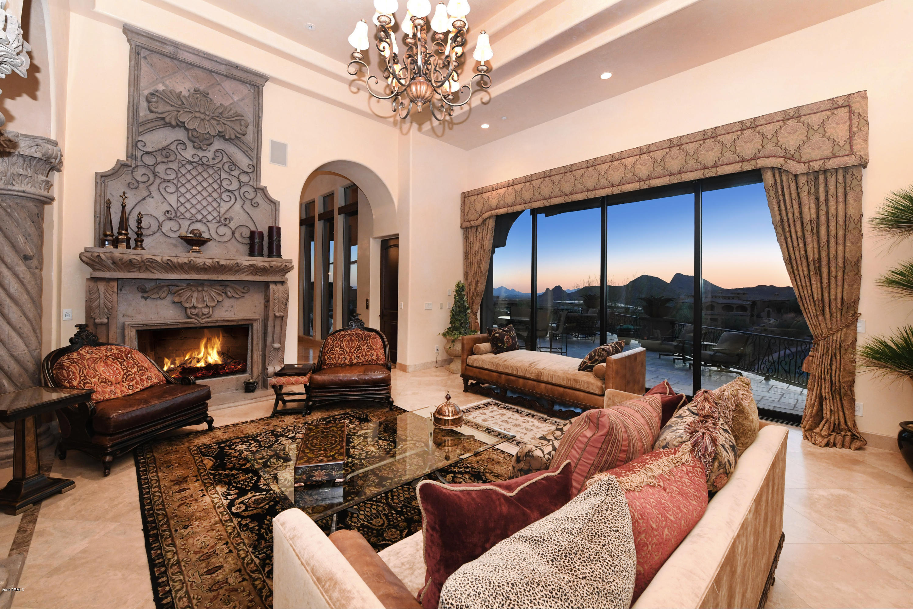 Beyond its own private gate this luxurious 5-bedroom custom home sits high on the hillside.  Gorgeous interior matched by panoramic views of the entire valley.  Entertainer's delight with both indoor and outdoor al-fresco living.  Gourmet kitchen offers elaborate appliance package, 2 islands, and butler's pantry.  Formal living room and dining room with wine room, wet bar and access to private interior patio.  Luxurious master suite with fireplace, stunning views, coffee bar, huge custom closet and laundry.  Lower level bedroom en-suite with breakfast bar.  Two upper level bedroom en-suites are spacious with huge closets & bathrooms.  Elegant office with built-ins, Theater room, and two laundry rooms.  Outdoor entertaining area has over 2,000 Sq Ft view deck, misting system, pool, spa, and outdoor custom kitchen.  Car enthusiast will love the 6-car garage.   See attachment for list of amenities.